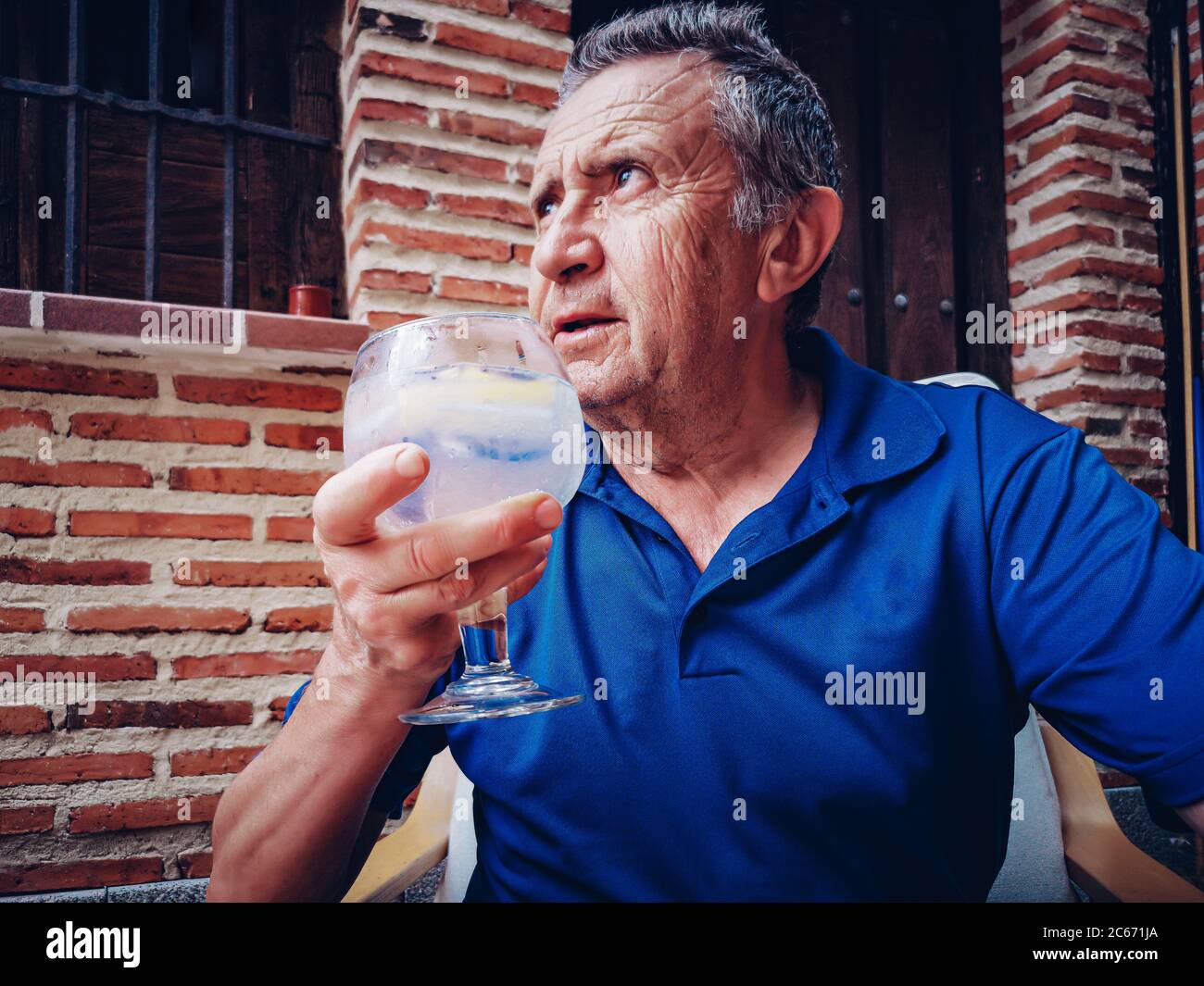 Retiree tasting a combination of premium gin with tonic water Stock Photo