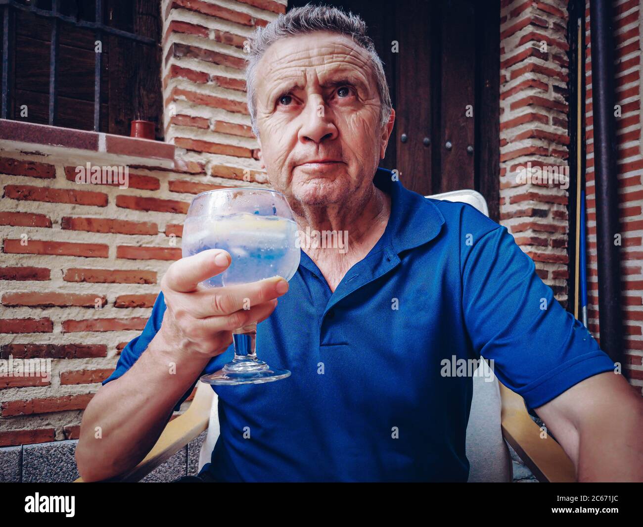 Retiree tasting a combination of premium gin with tonic water Stock Photo