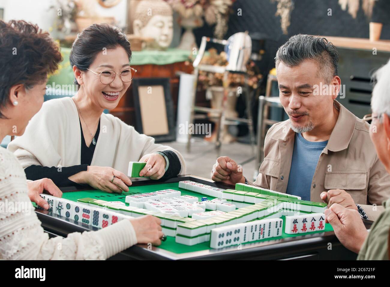 Happy old friends playing mahjong Stock Photo - Alamy