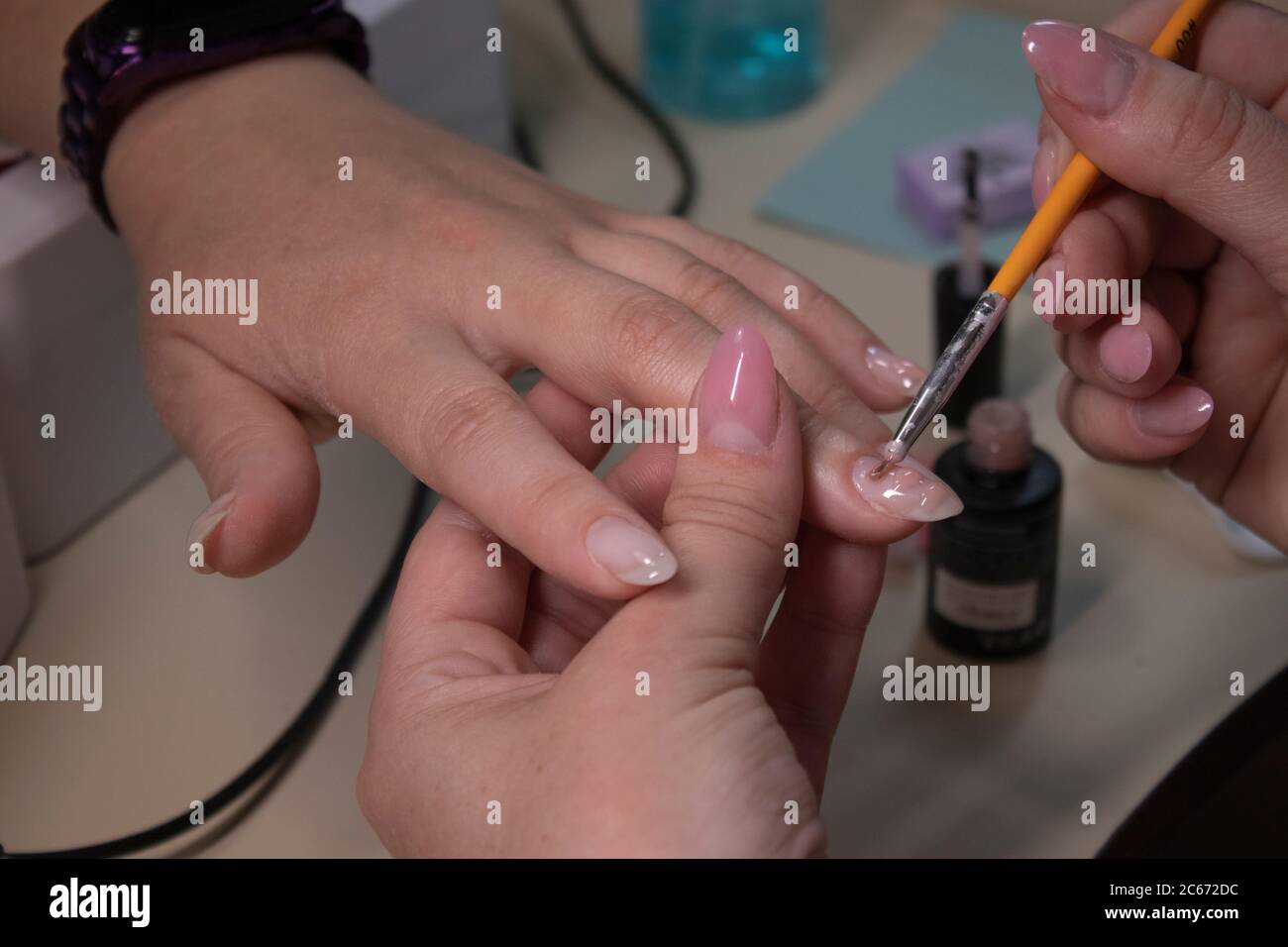 the process of doing manicure. Closeup of hands of professional ...