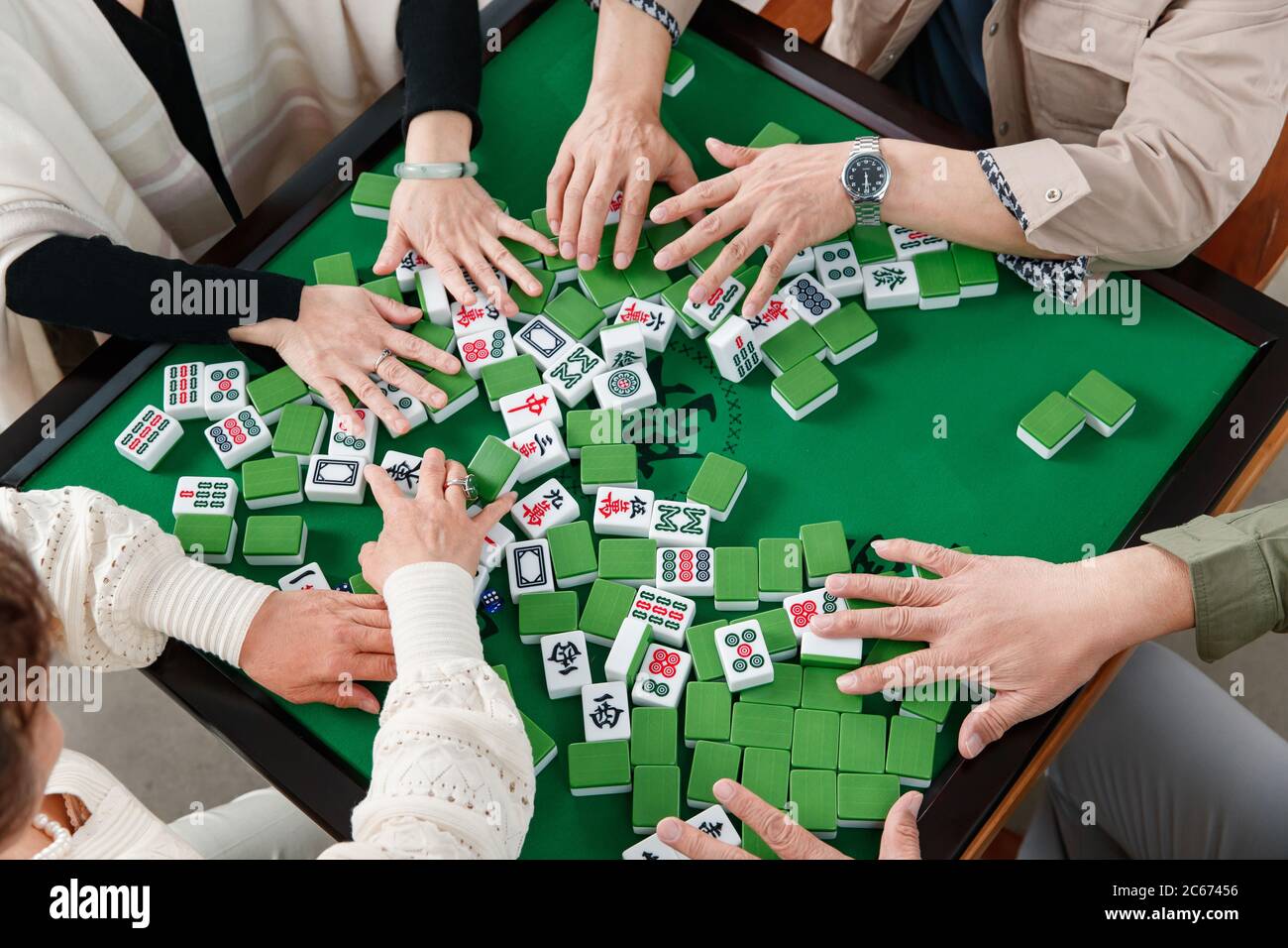 Happy old friends playing mahjong Stock Photo - Alamy