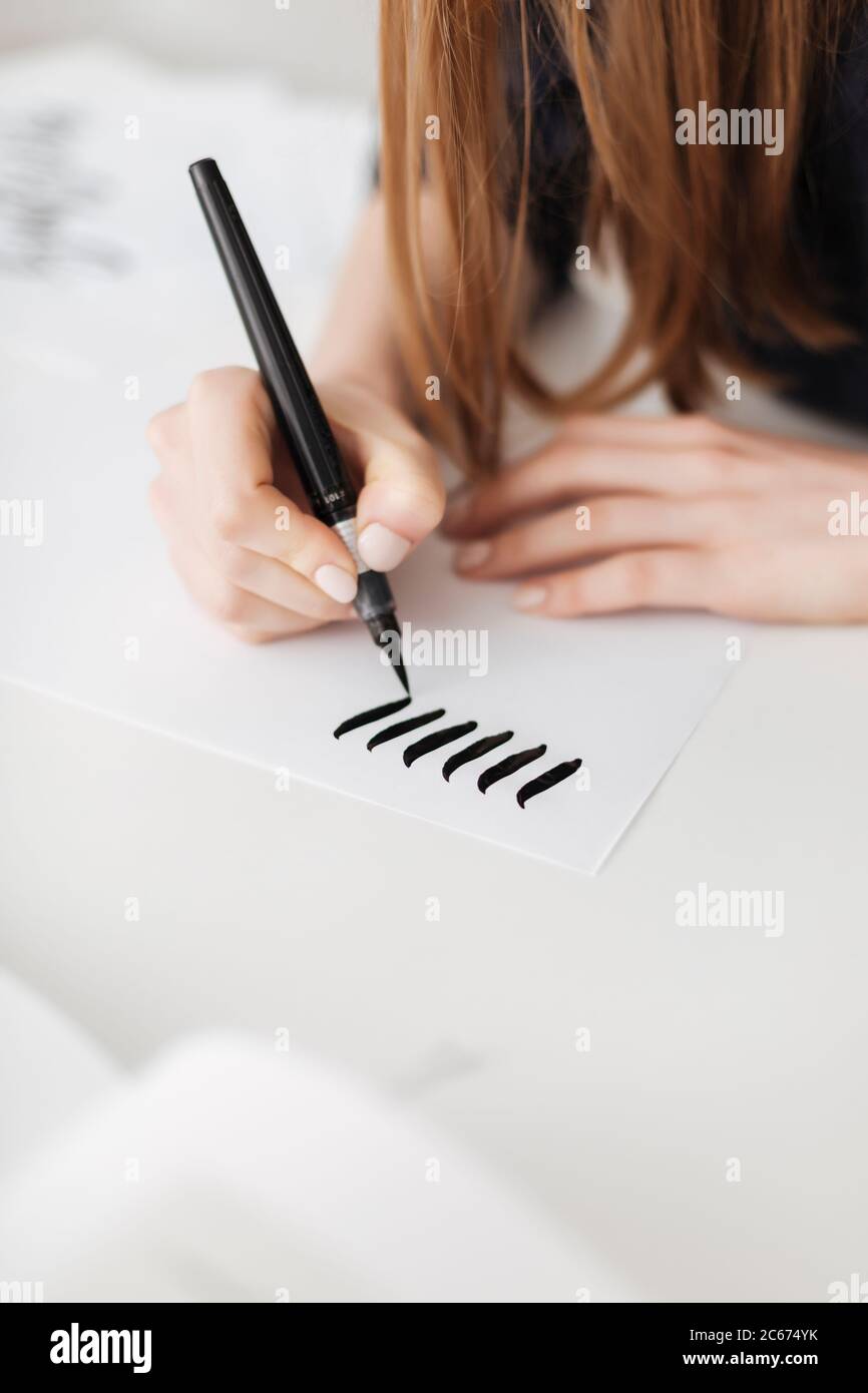 Close up photo of woman hands holding pen and writing on paper isolated ...