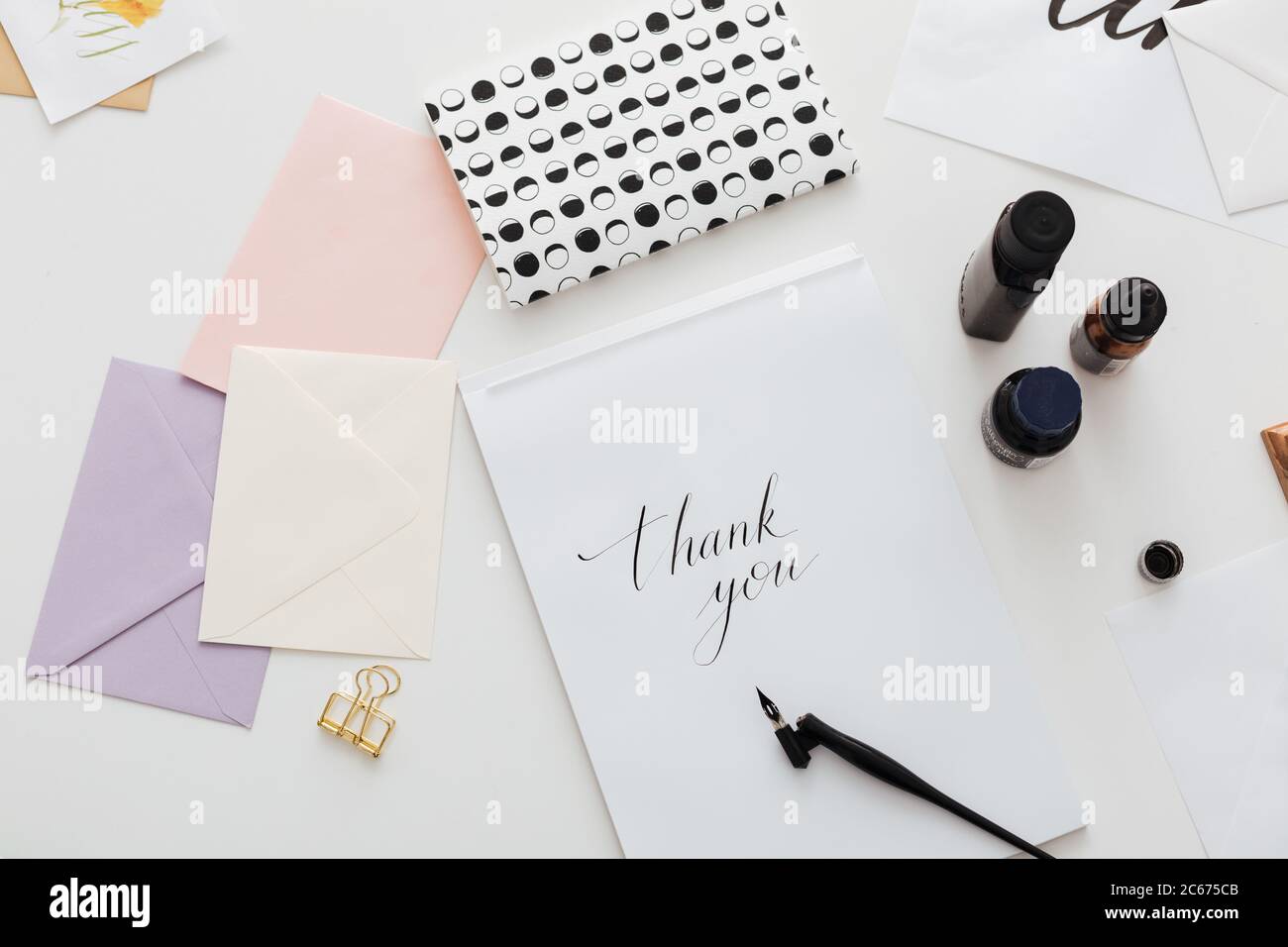 Close up photo of classic ink pen and beautiful notes on white desk isolated Stock Photo