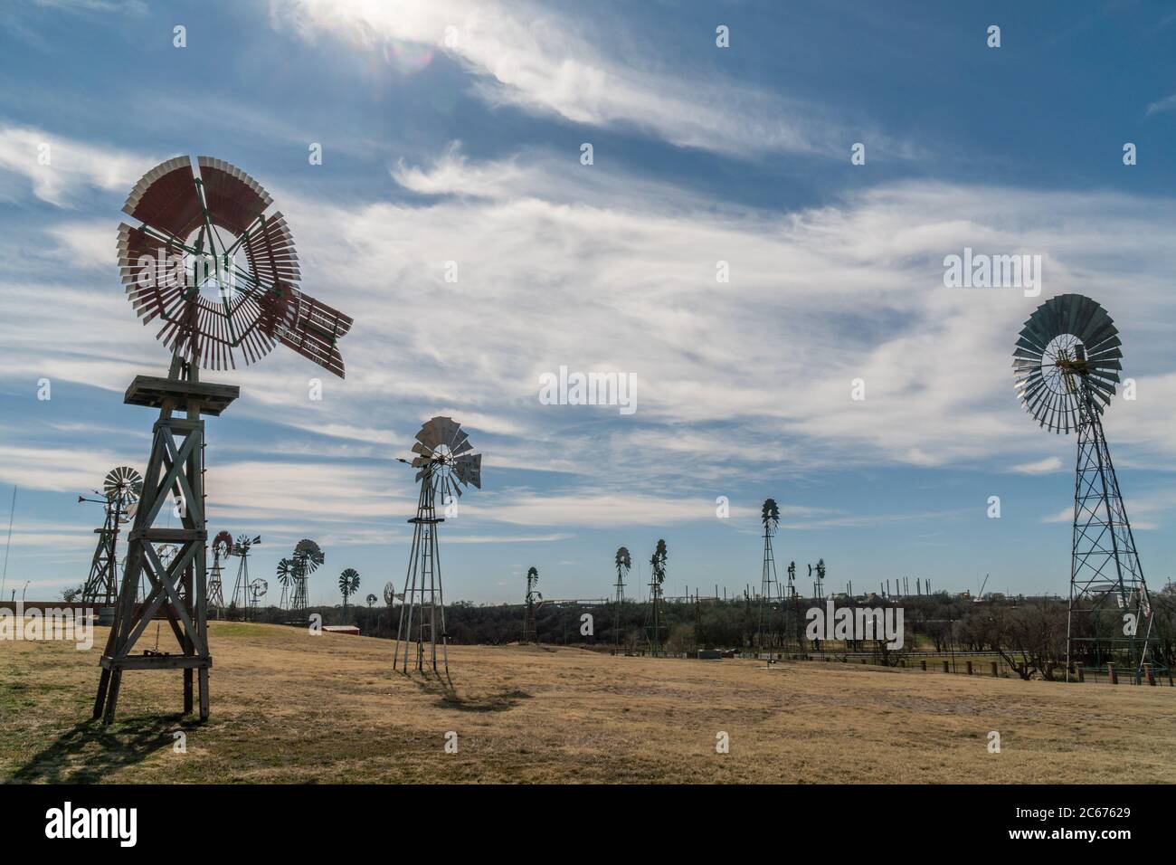 Retro/old-fashioned wind turbines in field Stock Photo