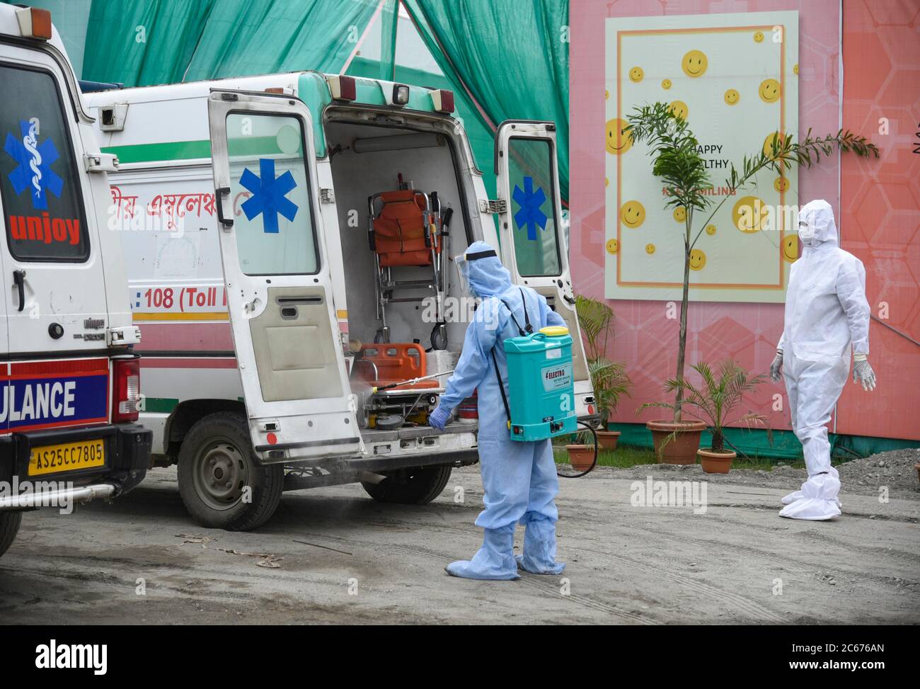 Worker sprays disinfectant on an ambulance after carry patients at a