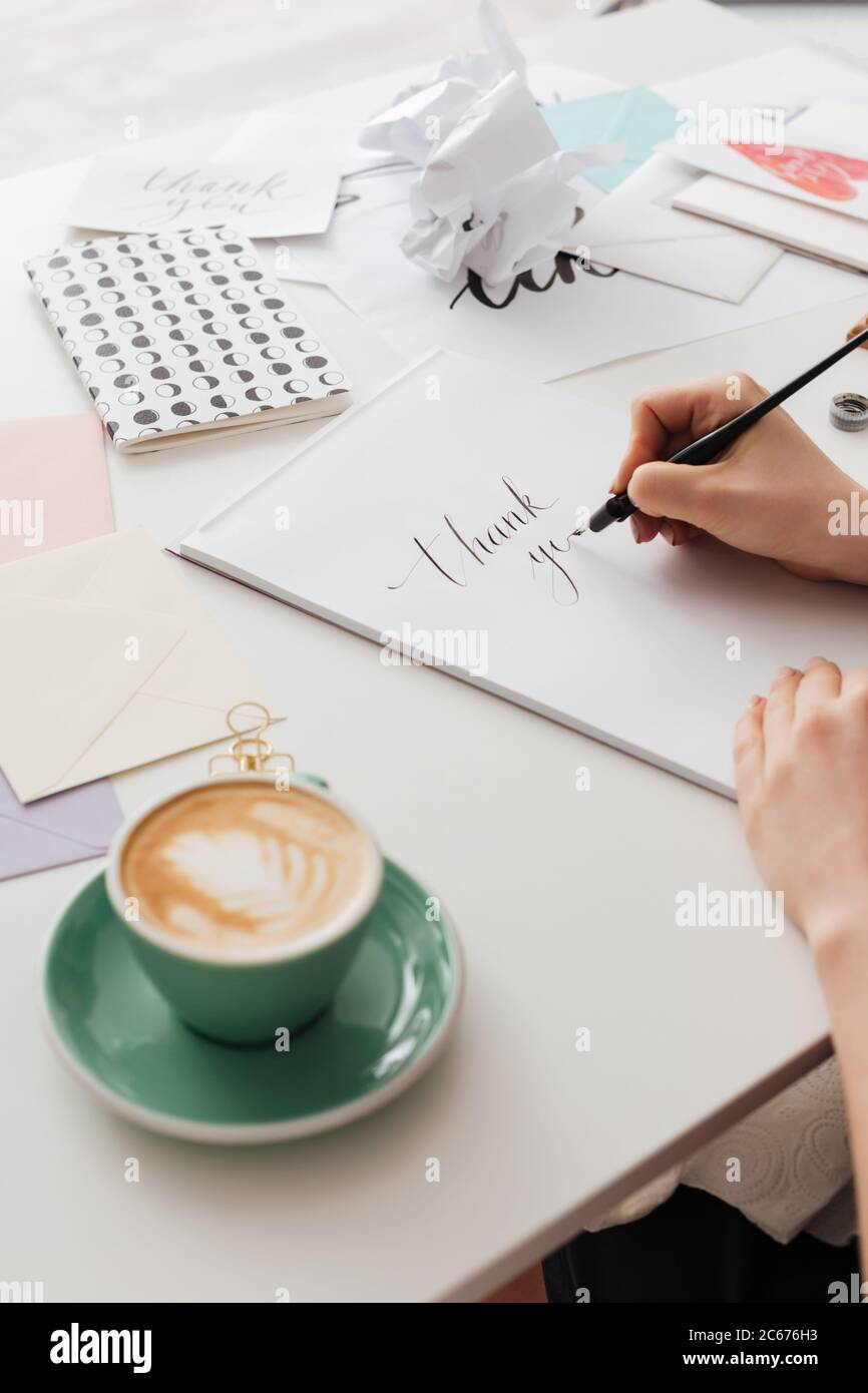 Close up photo of woman hands holding classic ink pen while writing ...