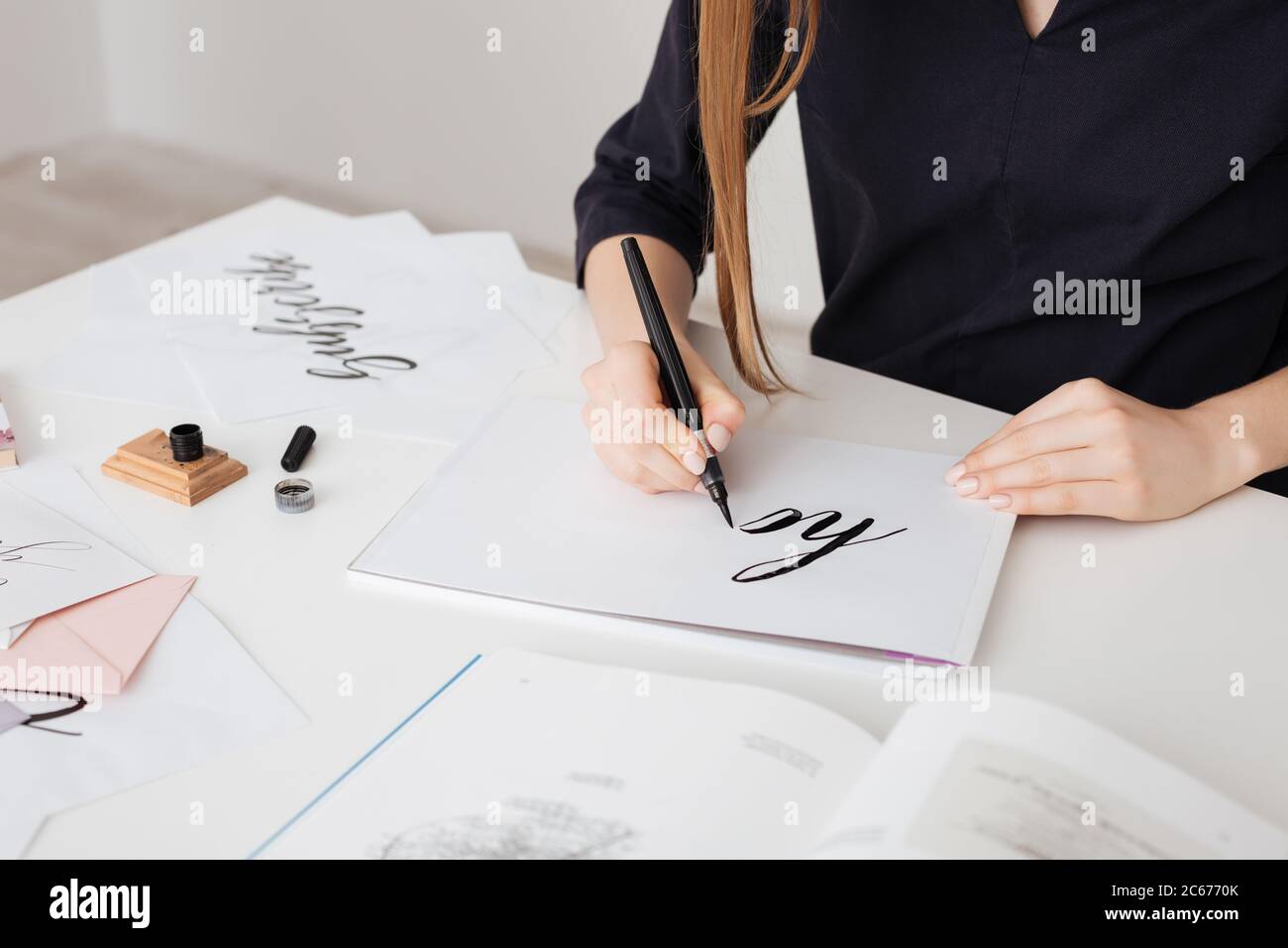 Portrait of young woman hands writing beautiful notes on paper on desk isolated Stock Photo