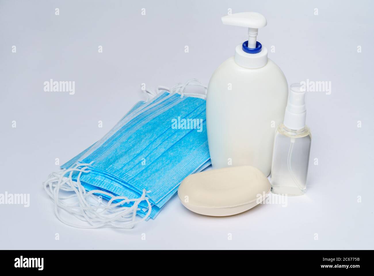 bottle of lotion, sanitizer or liquid soap and protective mask over ...