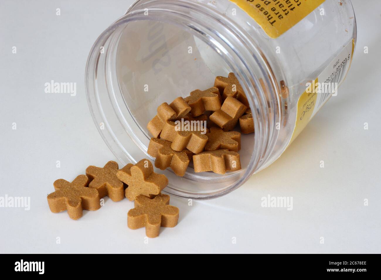 Dog treats spilling from jar Stock Photo Alamy
