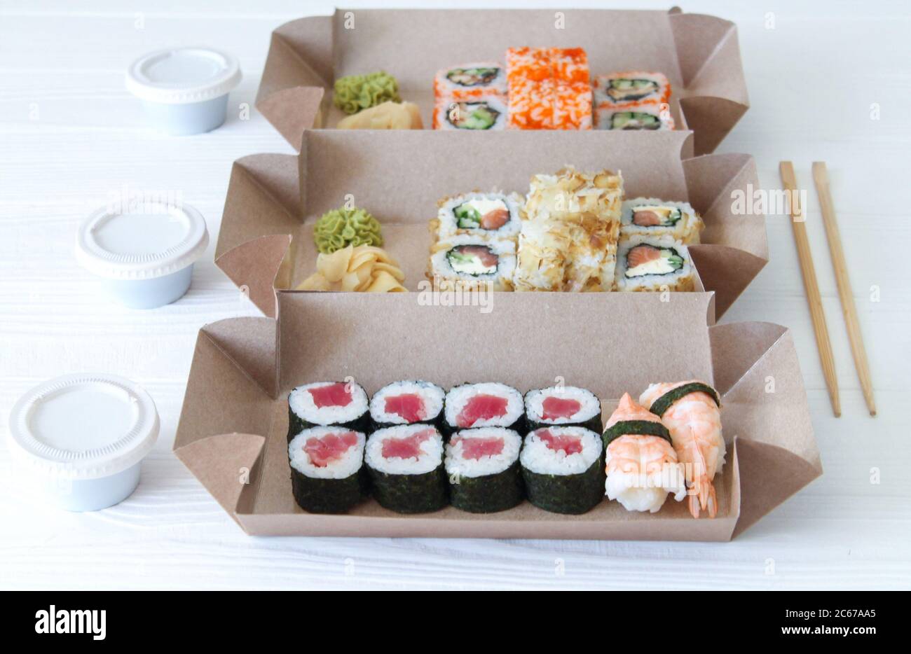 Lunch time concept. Japanese sushi in take away biodegradable boxes for  dinner at home or at work. Close-up Stock Photo - Alamy