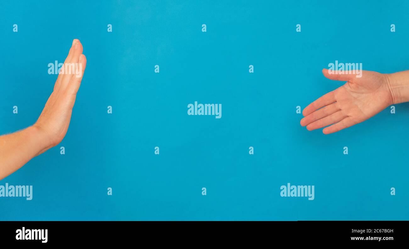 No handshake concept on blue background with copy space Stock Photo