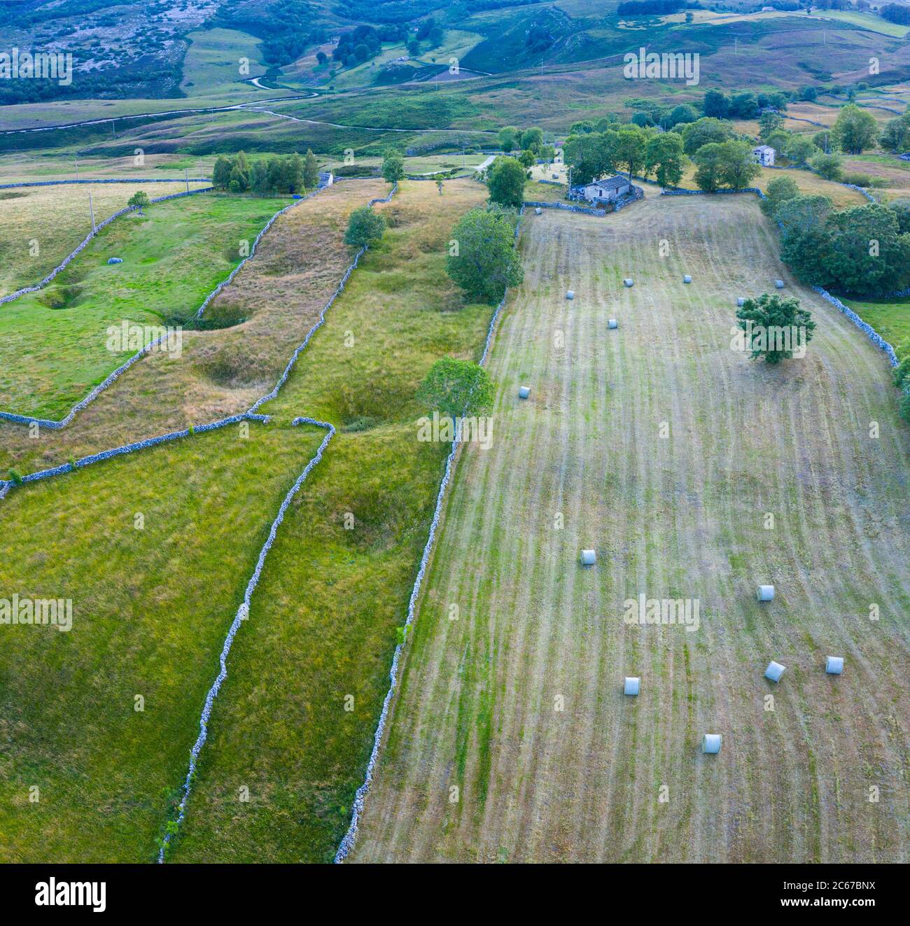 Spring landscape of mowing meadows and pasiega cabins near Puerto del Portillo de Lunada. Pasiegos Valleys. Merindades region. Burgos province. Commun Stock Photo