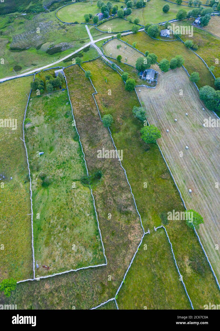 Spring landscape of mowing meadows and pasiega cabins near Puerto del Portillo de Lunada. Pasiegos Valleys. Merindades region. Burgos province. Commun Stock Photo