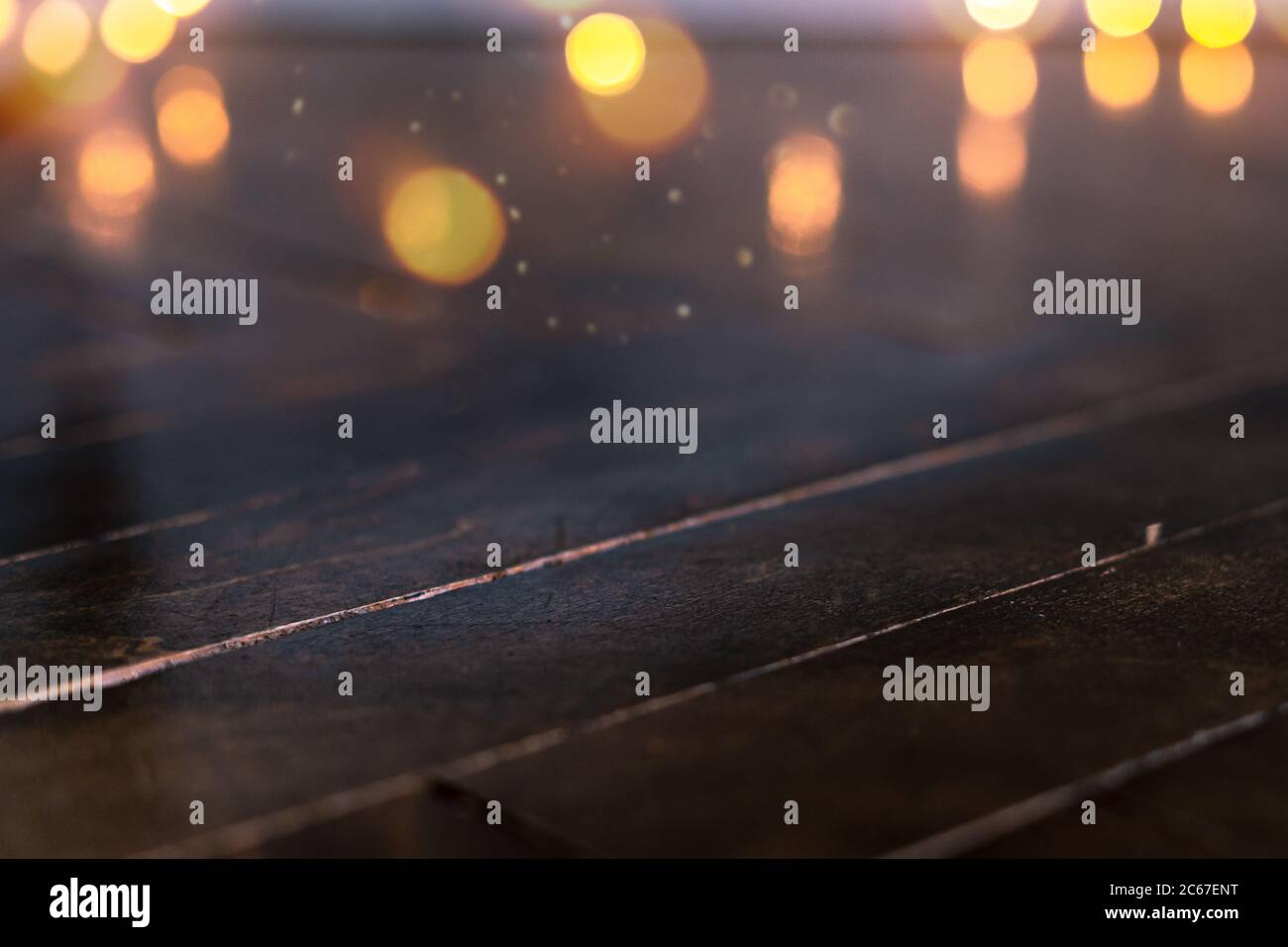 Empty rustic wooden table with blurred Christmas lights at background ...