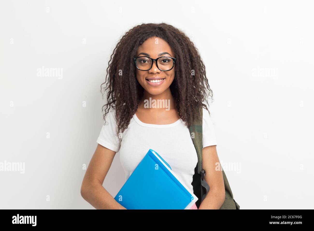 Portrait of a smiling African American female student girl in glasses ...