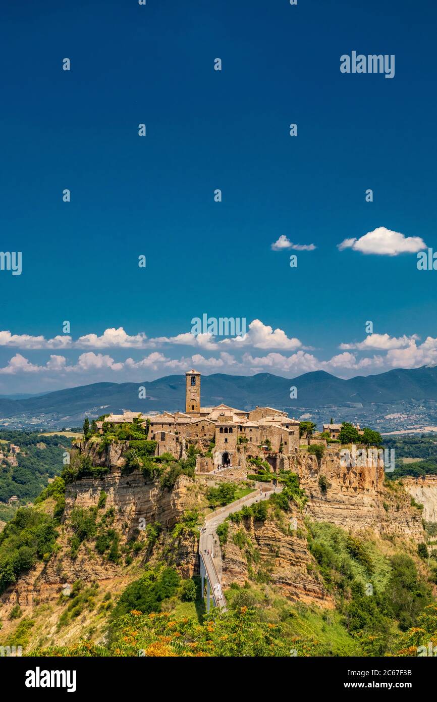 View of the medieval town of Civita di Bagnoregio, located on the top of a spur of tuff rock, in the middle of the valley of the badlands. Connected t Stock Photo
