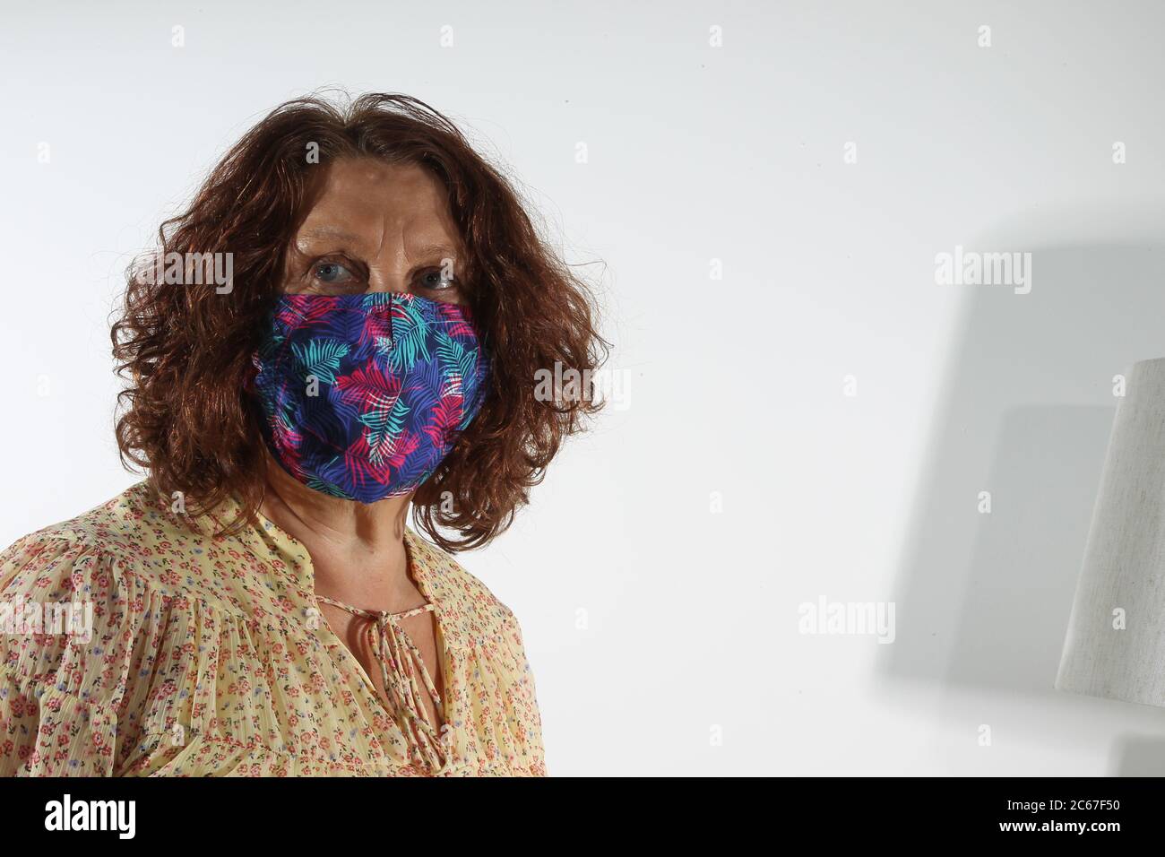 Middle aged woman with facemask Stock Photo