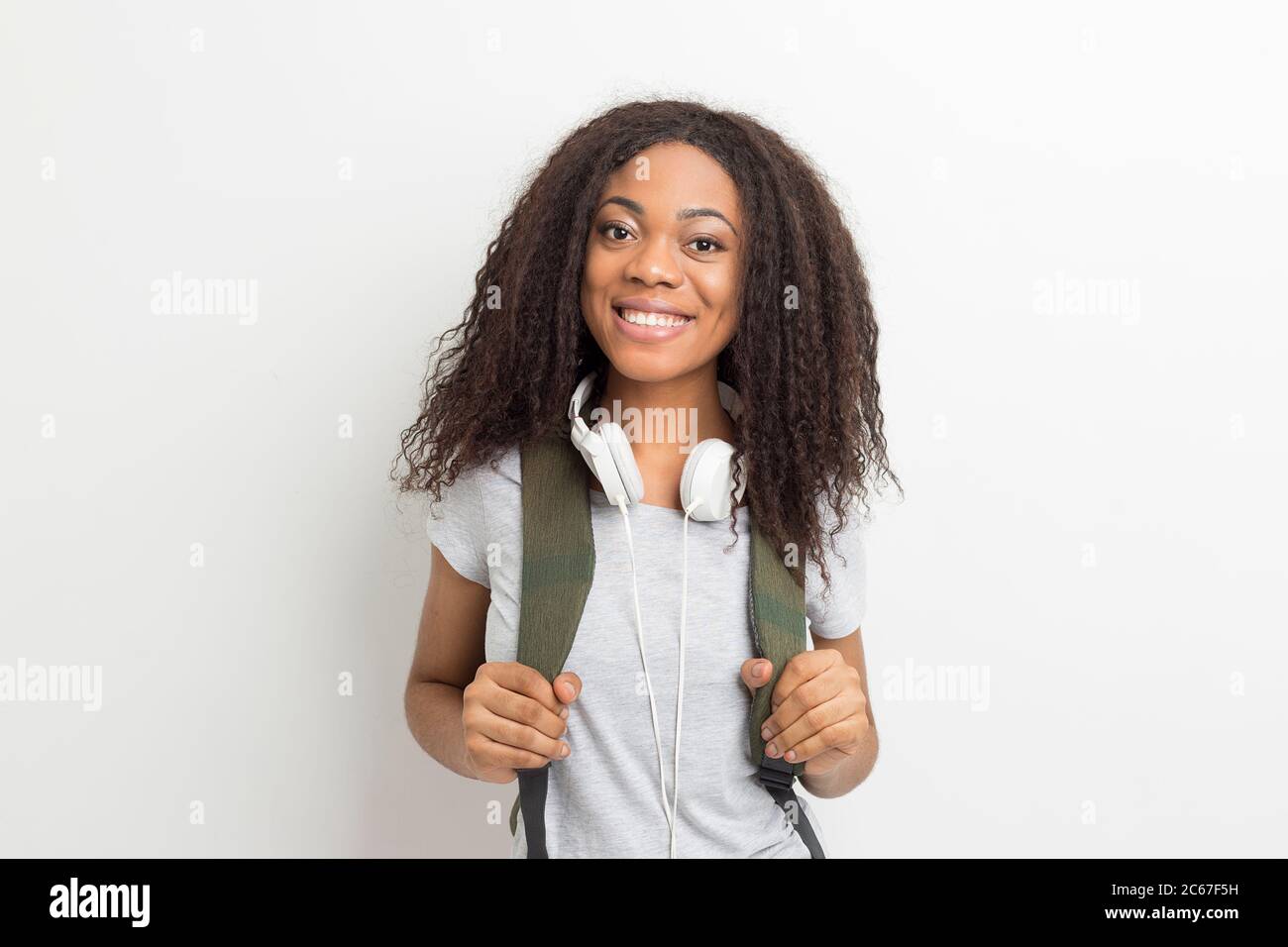Portrait of a smiling African American young female student woman with ...