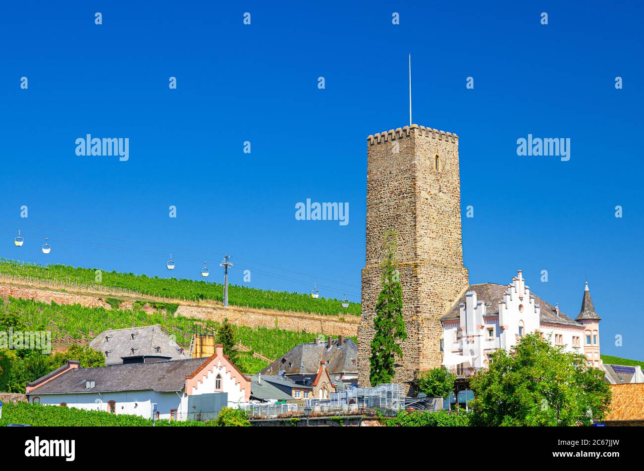 Stone tower building, cable car cableway above vineyards fields of river Rhine Valley hills in Rudesheim am Rhein historical town centre, blue sky background, State of Hesse, Germany Stock Photo