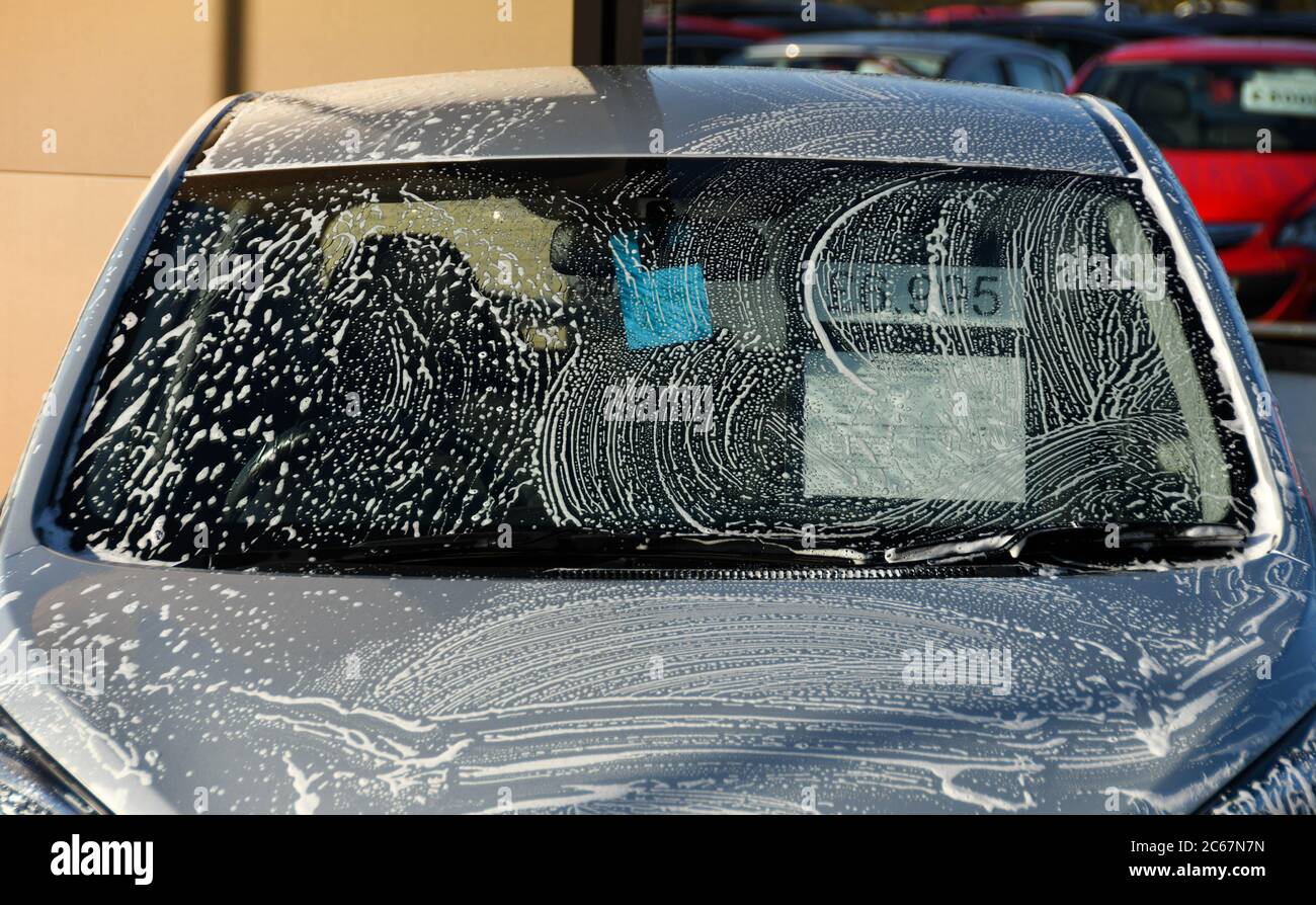 Pontypridd, Wales - December 2017: Soap suds on a car being washed on the forecourt of a garage Stock Photo