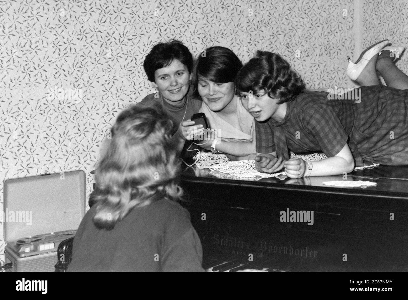four young females at piano recording music and singing using reel to reel tape recorder 1960s hungary Stock Photo