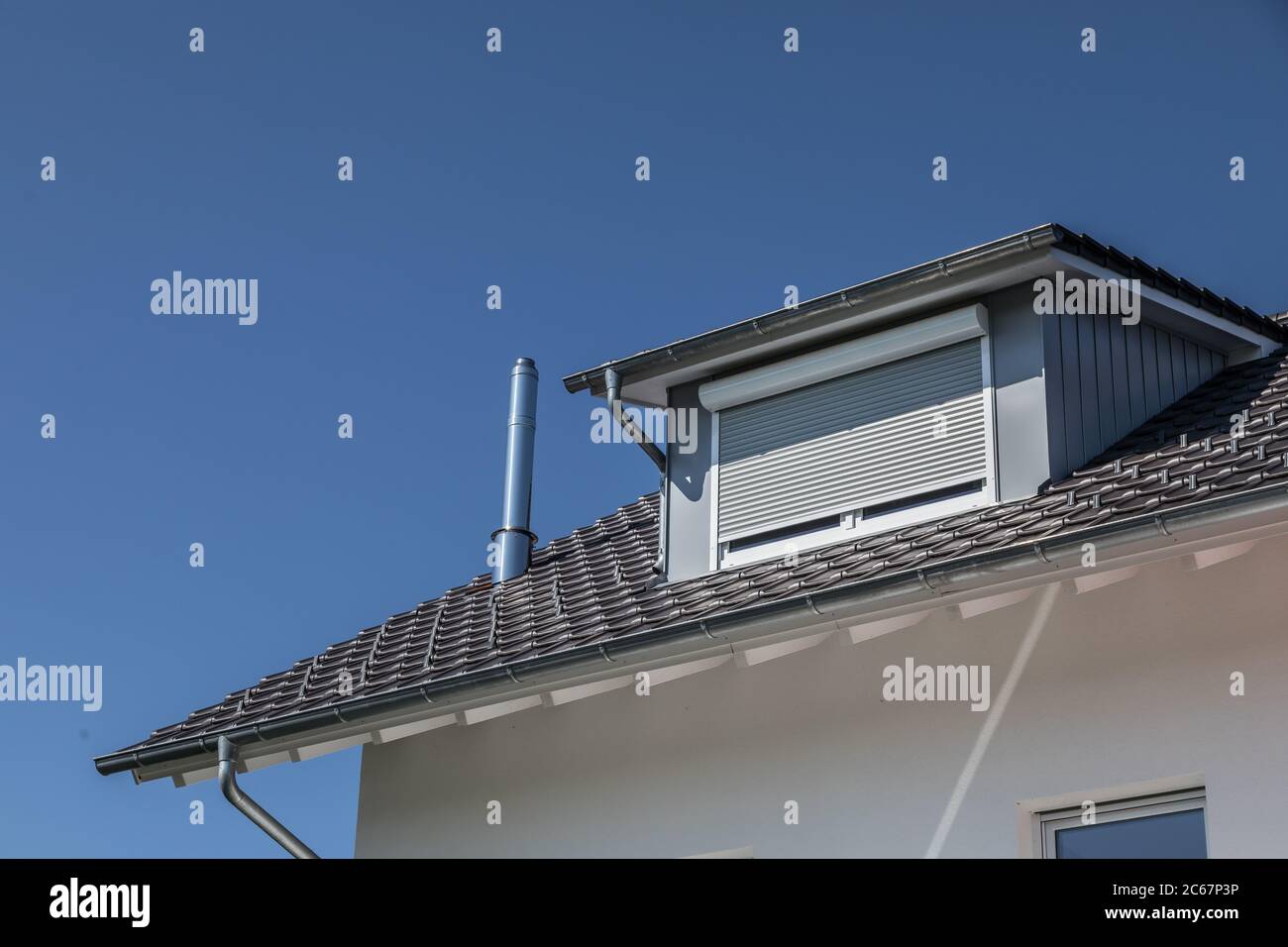 dormer window with sun shade on gray rooftop Stock Photo Alamy