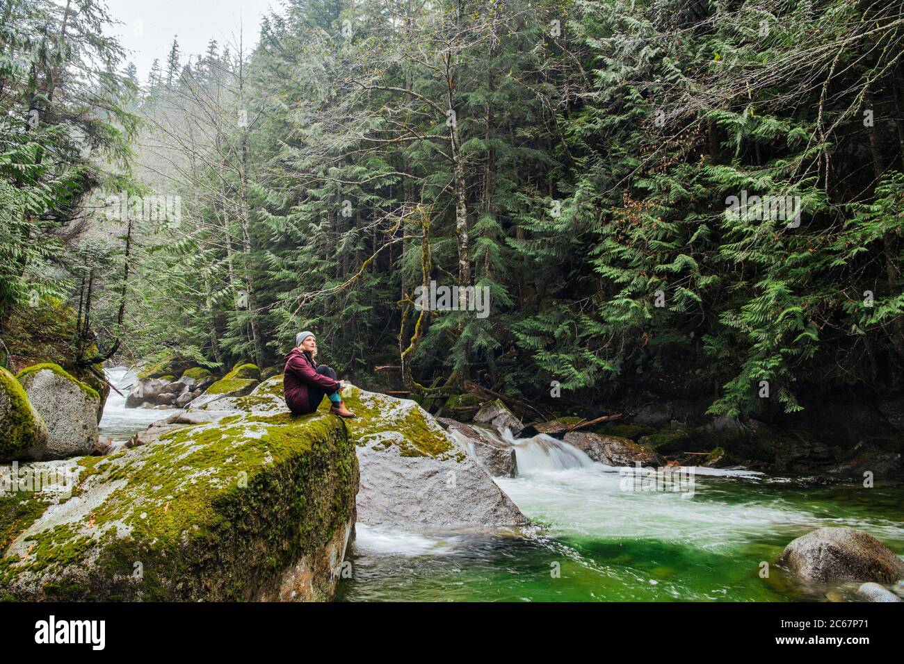 View of woman near river on Deception Falls National Recreation Area, Washington, USA Stock Photo