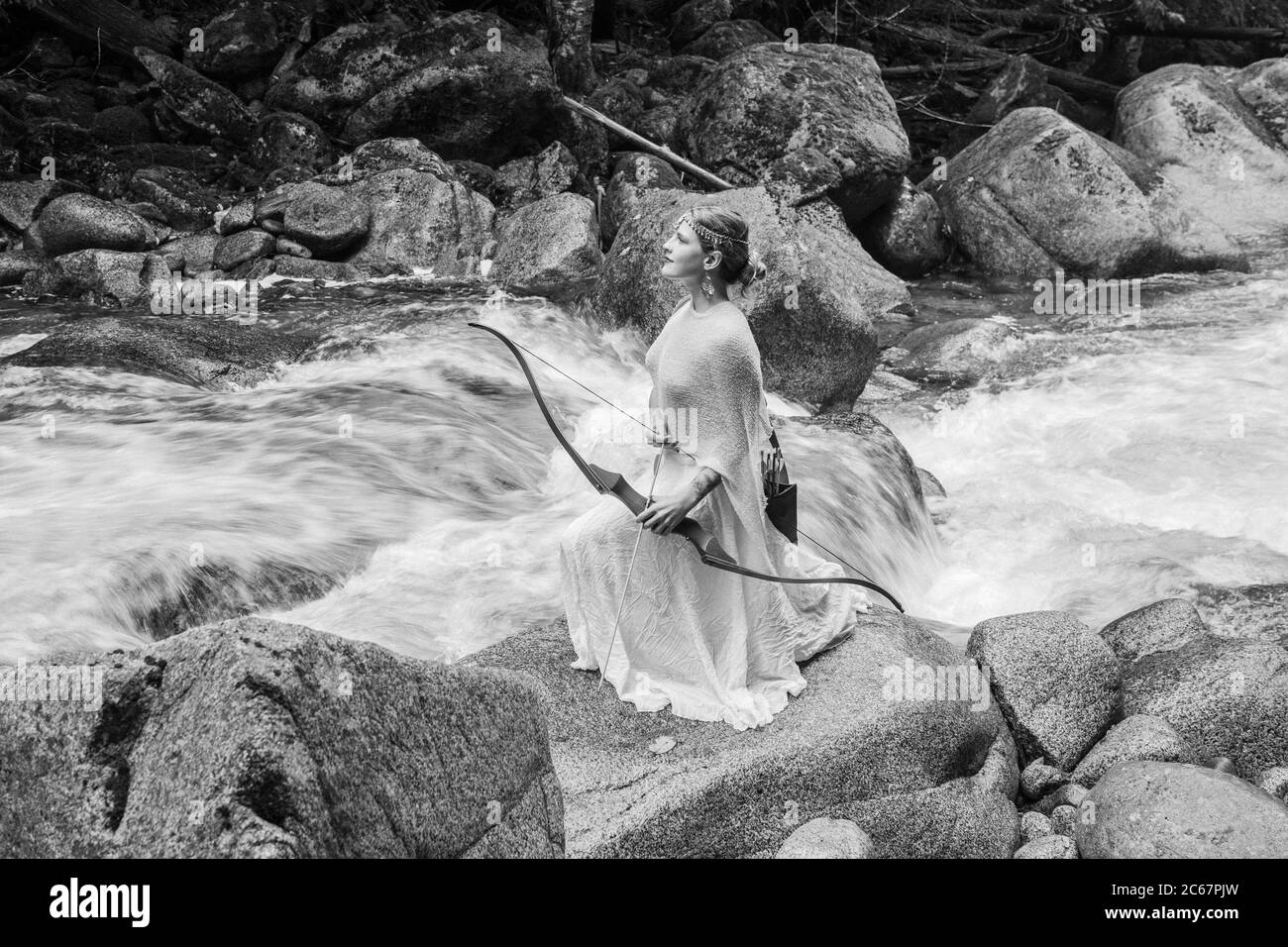 Woman with bow, Deception Falls National Recreation Area, Washington, USA Stock Photo