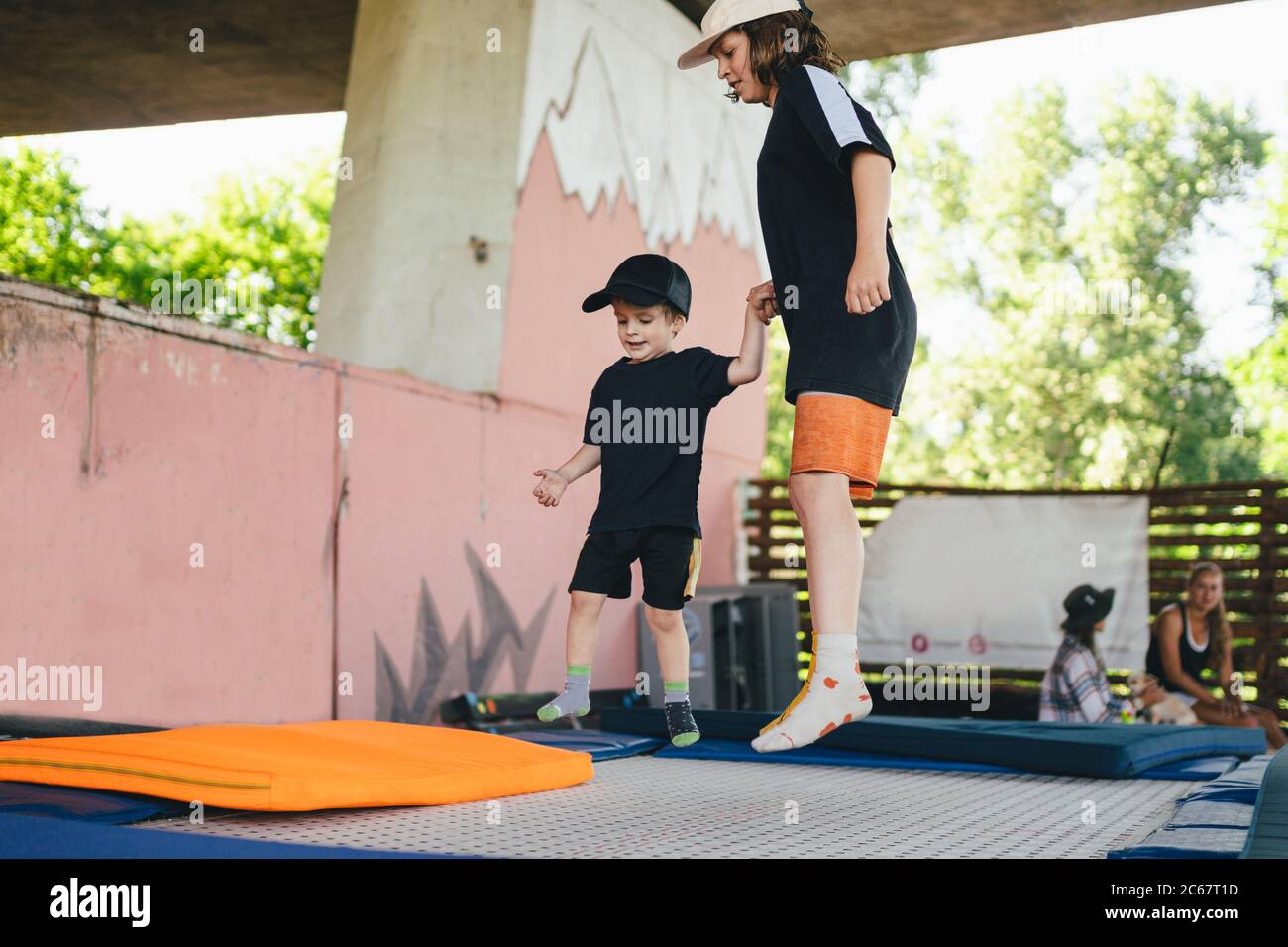 Two little boys jumping on trampoline in sport center. Kids having fun ...