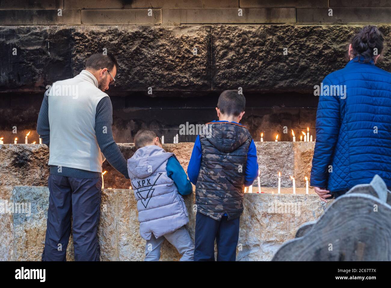 People lighting candles in Our Lady of Lebanon Marian shrine and a