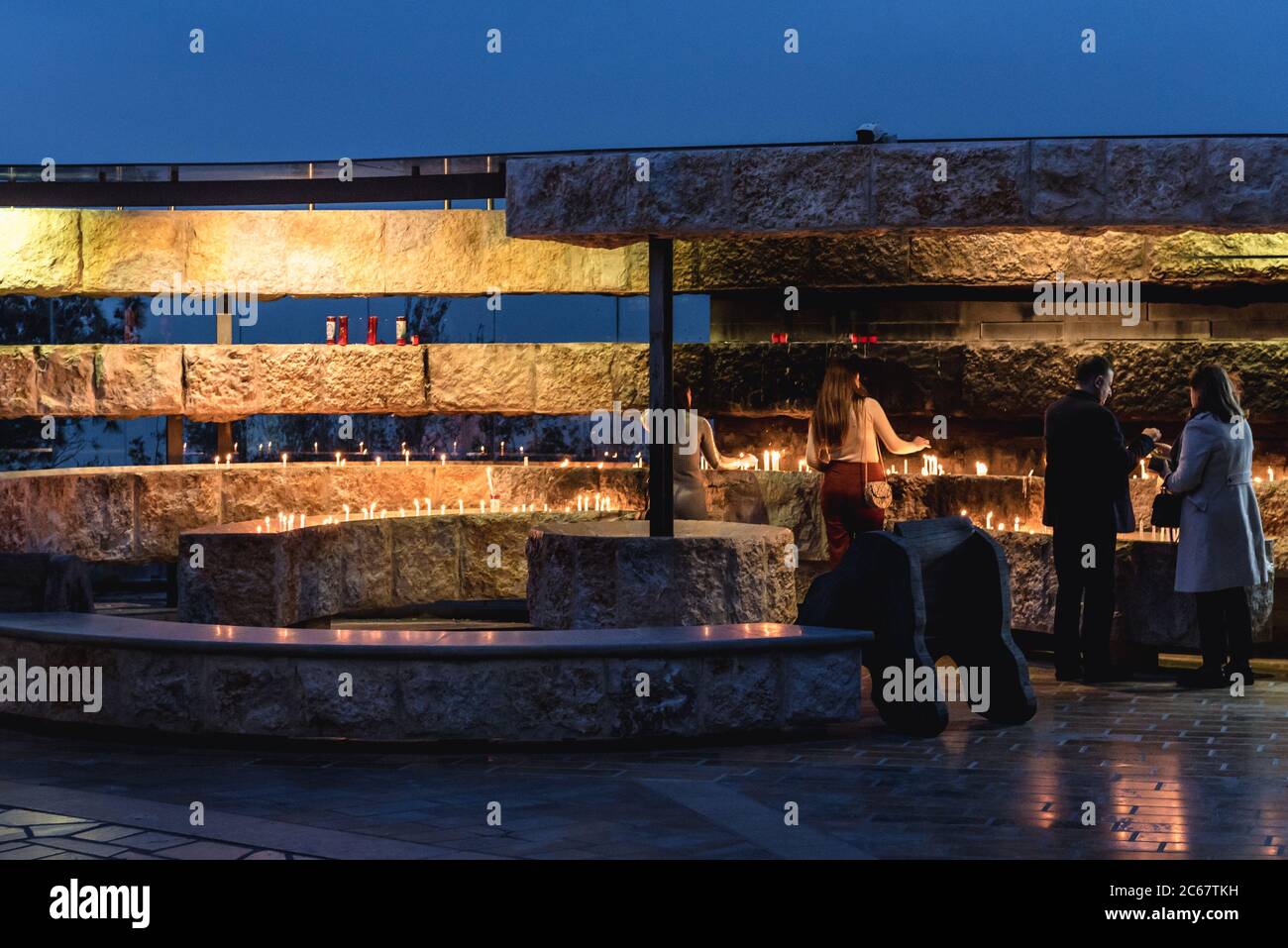 People lighting candles in Our Lady of Lebanon Marian shrine and a