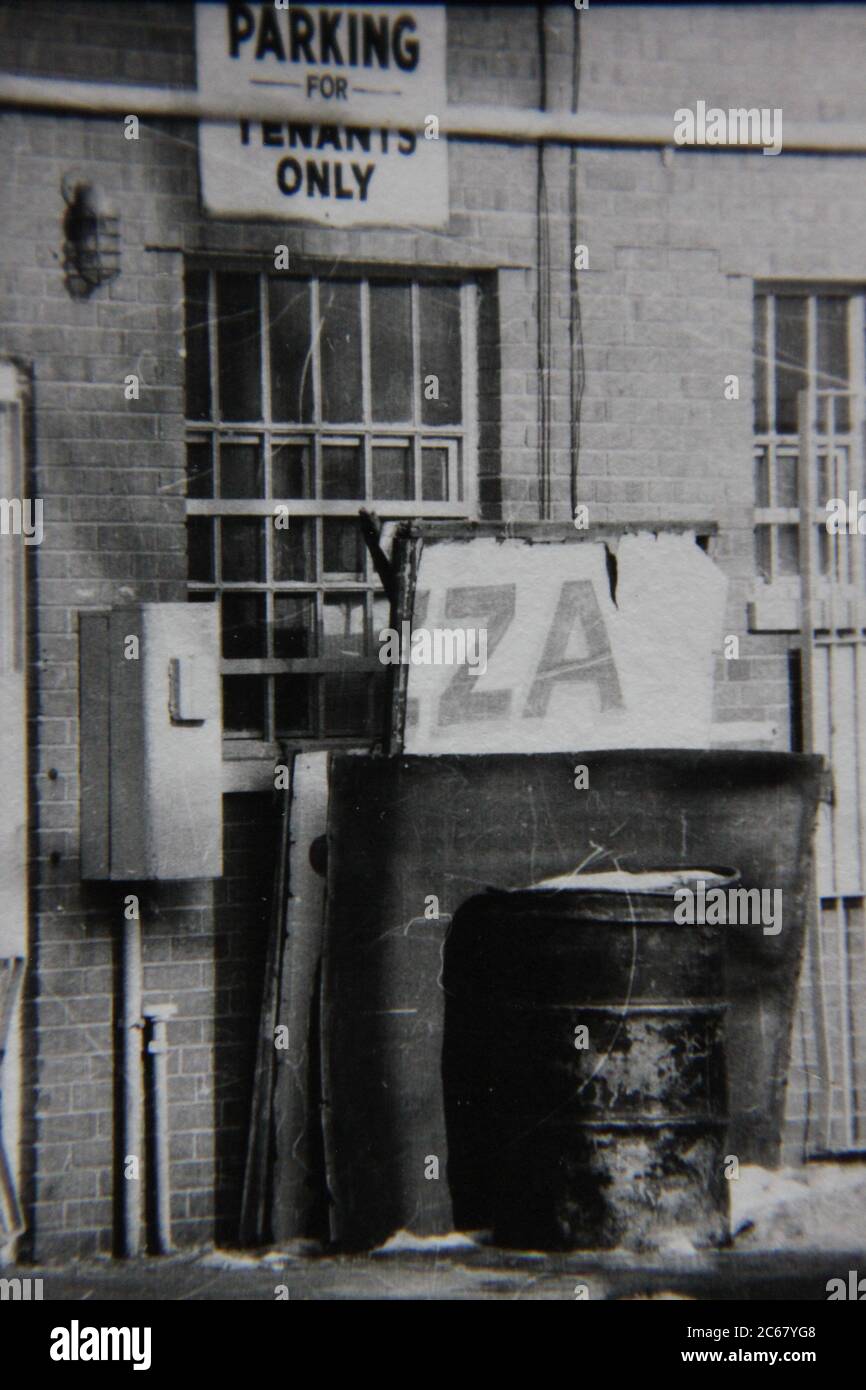 Fine 1970s vintage black and white photography of an underprivileged inner city back alley. Stock Photo