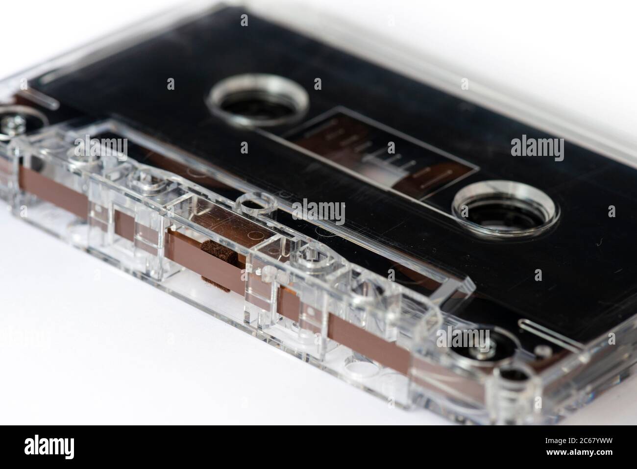 Magnetic tape head opening close up of black classic old audio cassette isolated on white Stock Photo