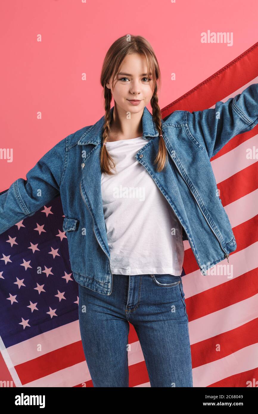 Young pretty smiling teenager girl with two braids in denim jacket
