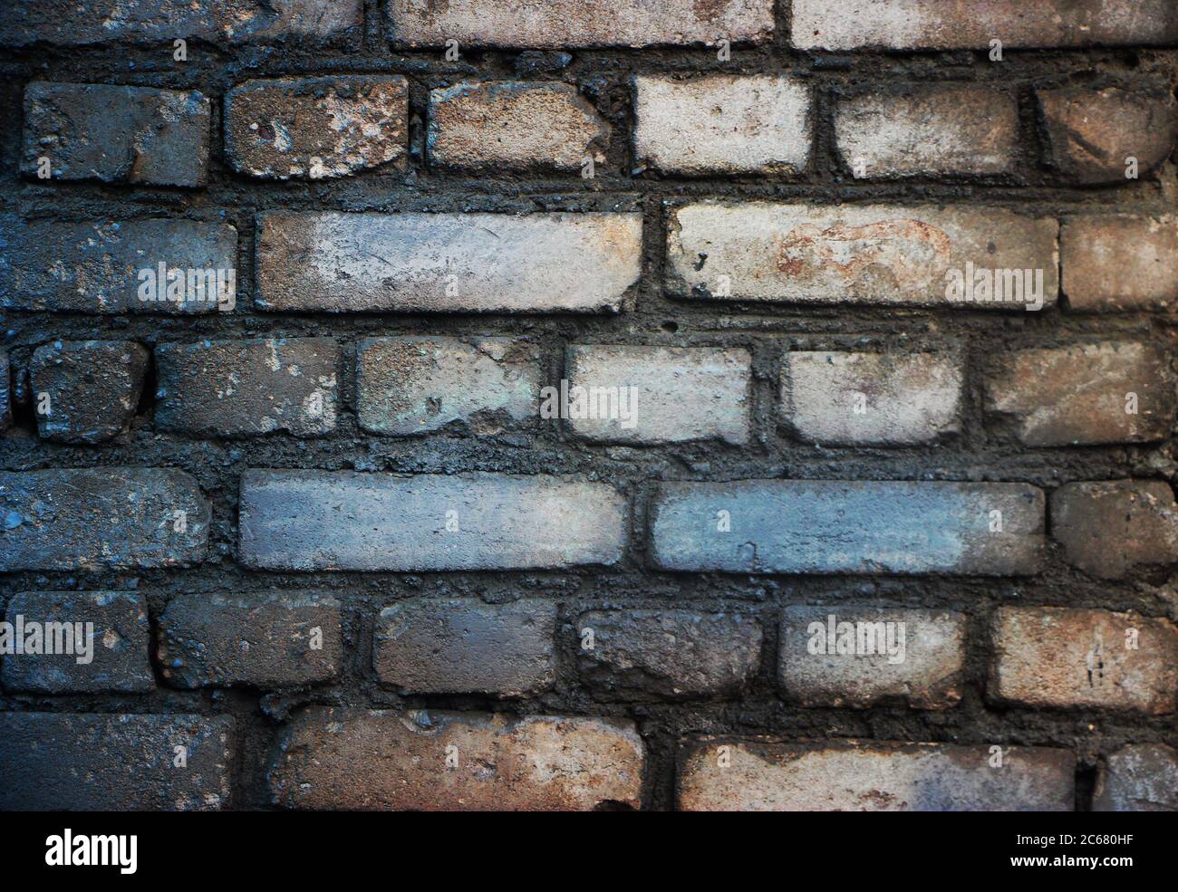 Old weathered grey brick wall closeup background Stock Photo