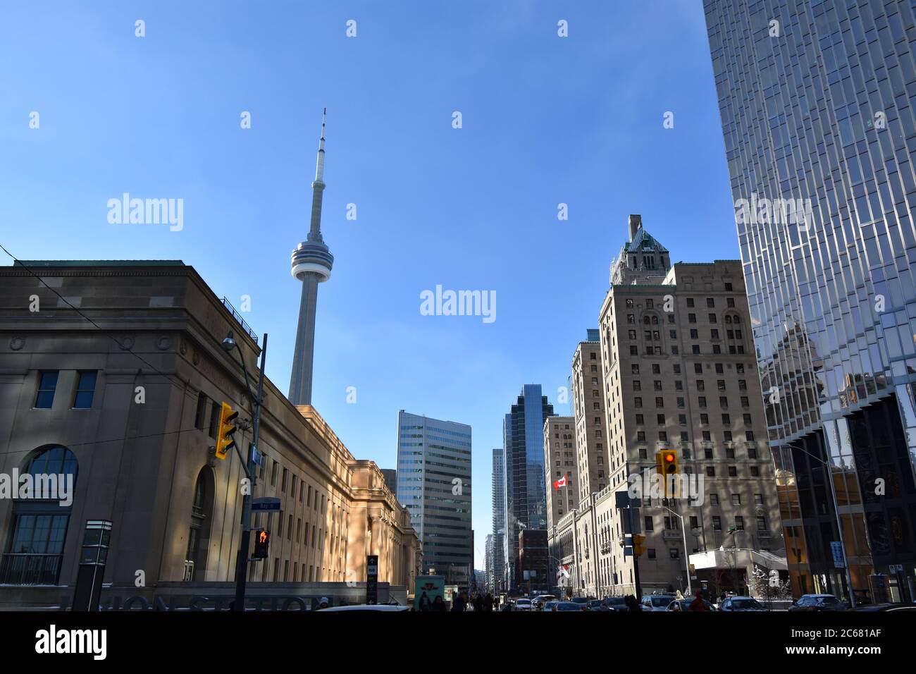 Front Street on a clear winters morning.  Union station and the Fairmont Royal York are visible on the street and the CN Tower rises from the station. Stock Photo