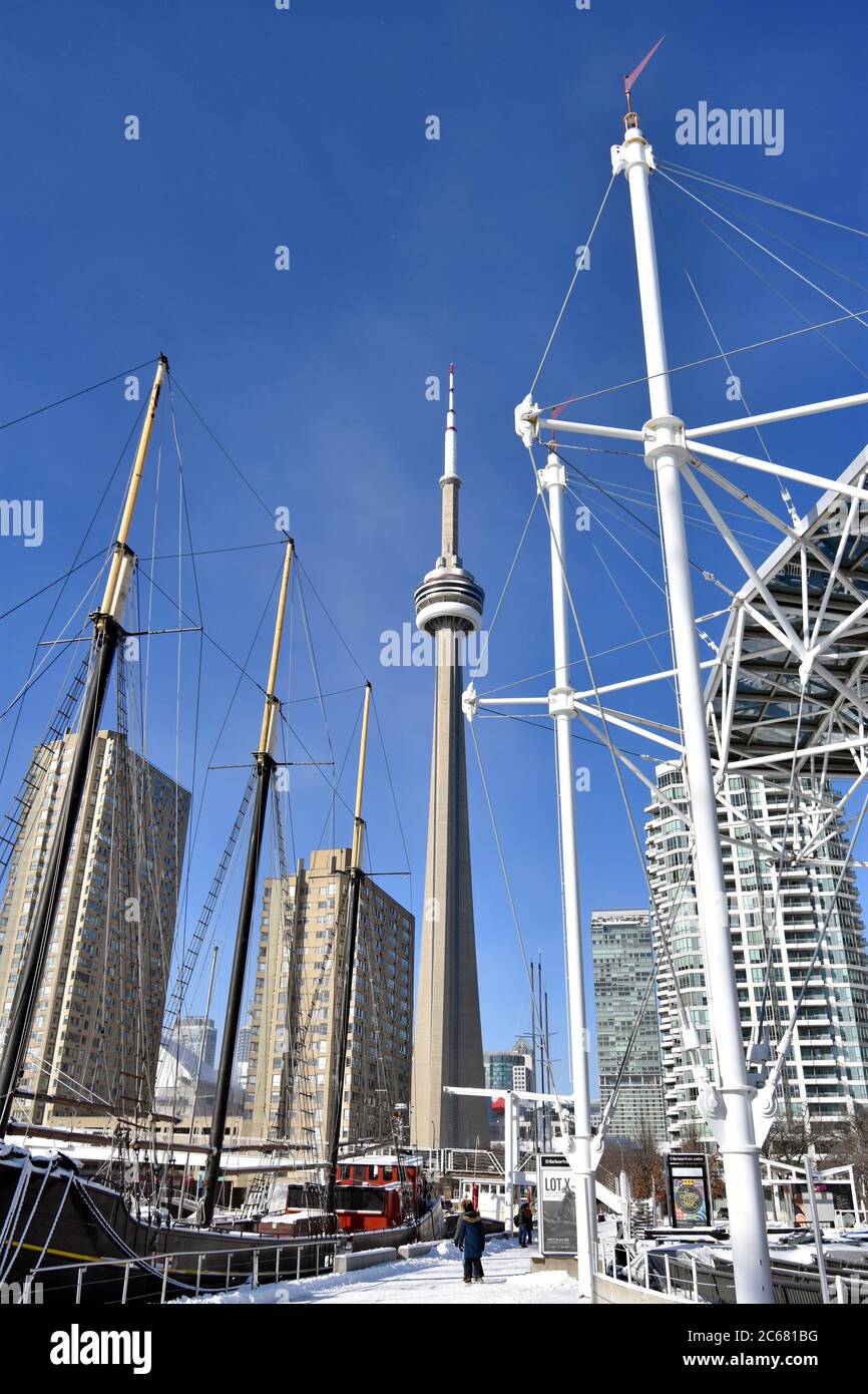 Ships sails can be seen on a clear day at the Harbour front centre in Toronto.  The CN Tower and other Tall building are seen against the blue sky. Stock Photo
