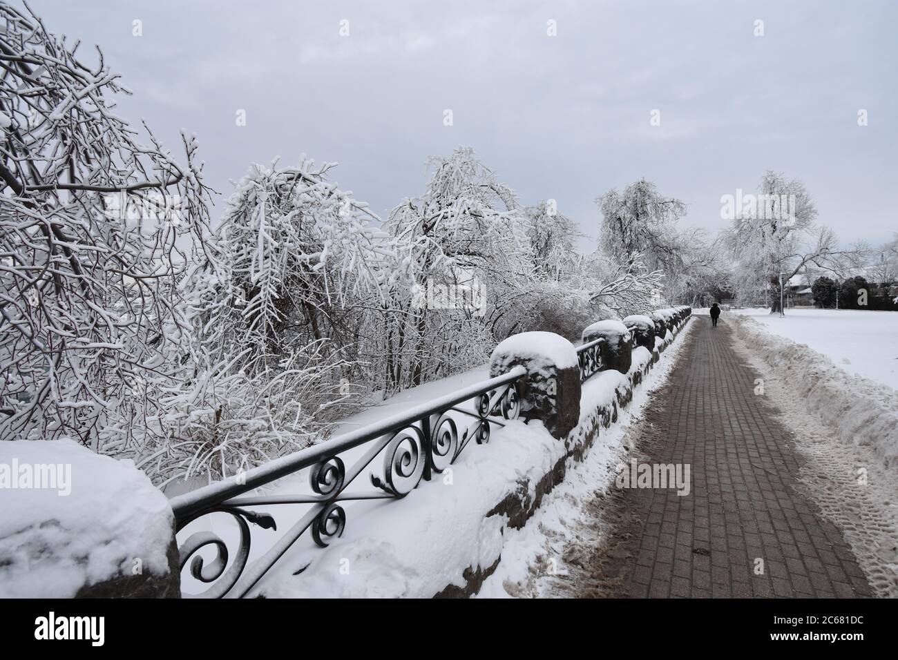 The riverside path in Queen Victoria Park during wintertime at Niagara Falls on the Canadian side.  Snow has been cleared from the pathway. Stock Photo