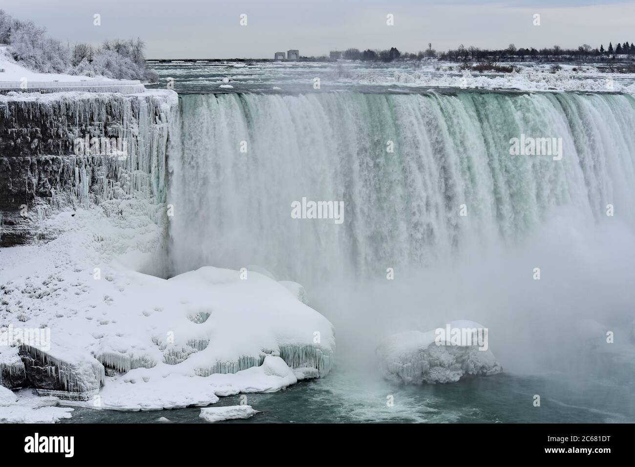Part of Horseshoe falls in the winter. Icicles hang from the rock face near to the waterfall