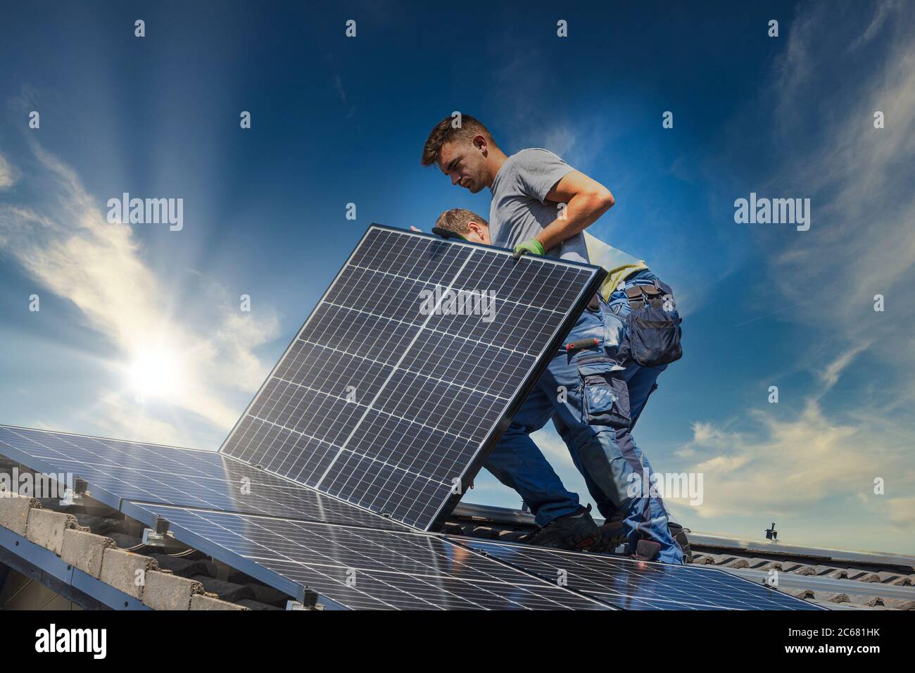 Installing solar photovoltaic panel system. Solar panel technician
