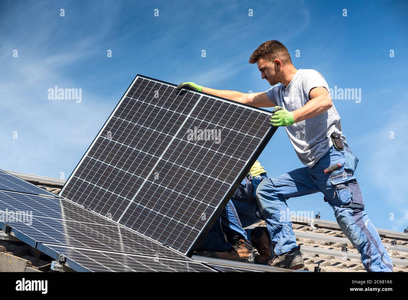 Installing solar photovoltaic panel system. Solar panel technician