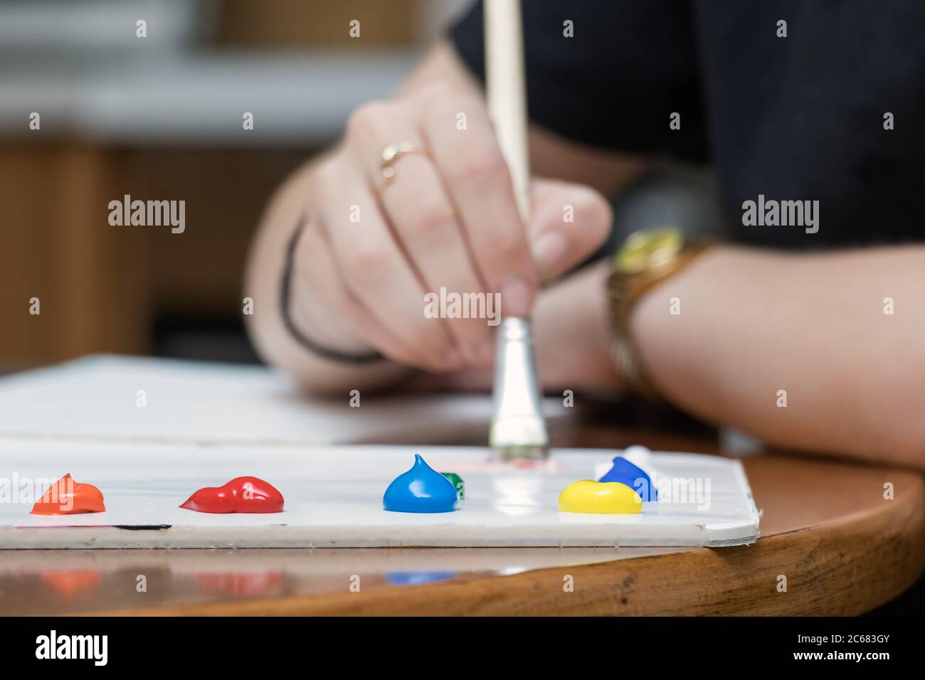 Close-up of paper painter color palette with acrylic paint on a table Stock Photo