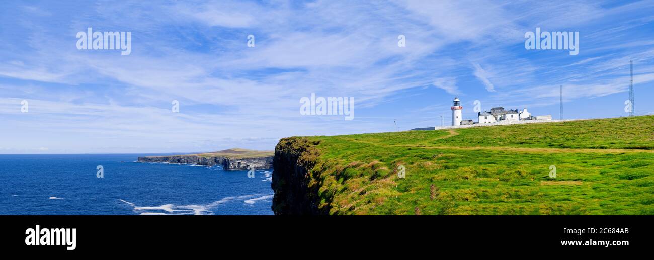 Atlantic Ocean coastline and Loop Head Lighthouse, County Clare, Ireland Stock Photo