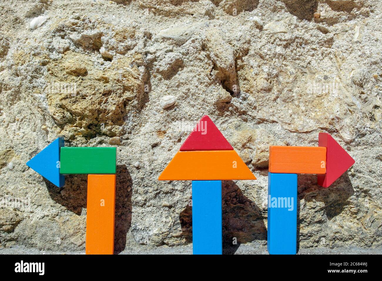 Detail of some arrows with a stone wall background Stock Photo