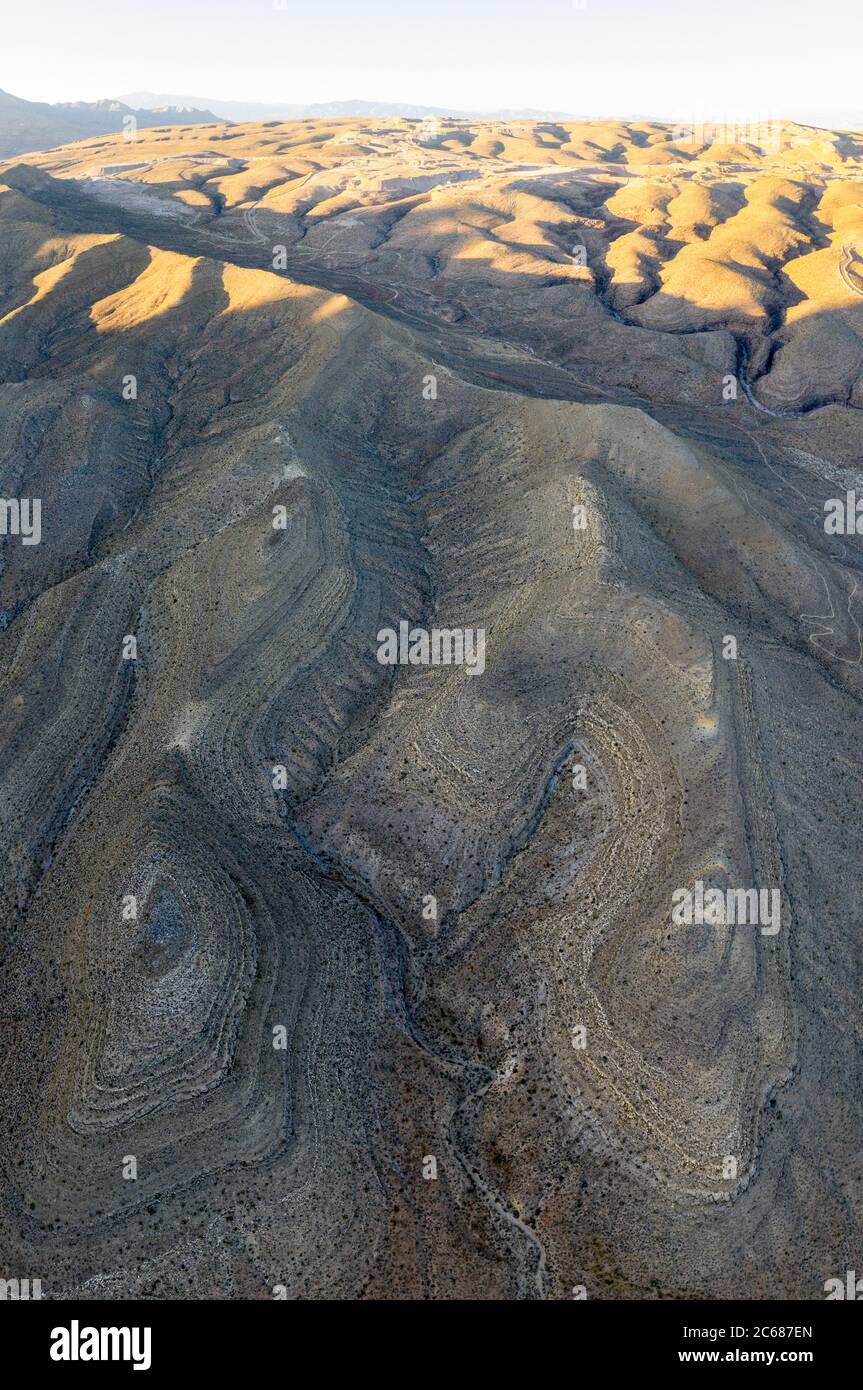 An aerial view shows the rugged, eroded desert landscape that surrounds ...