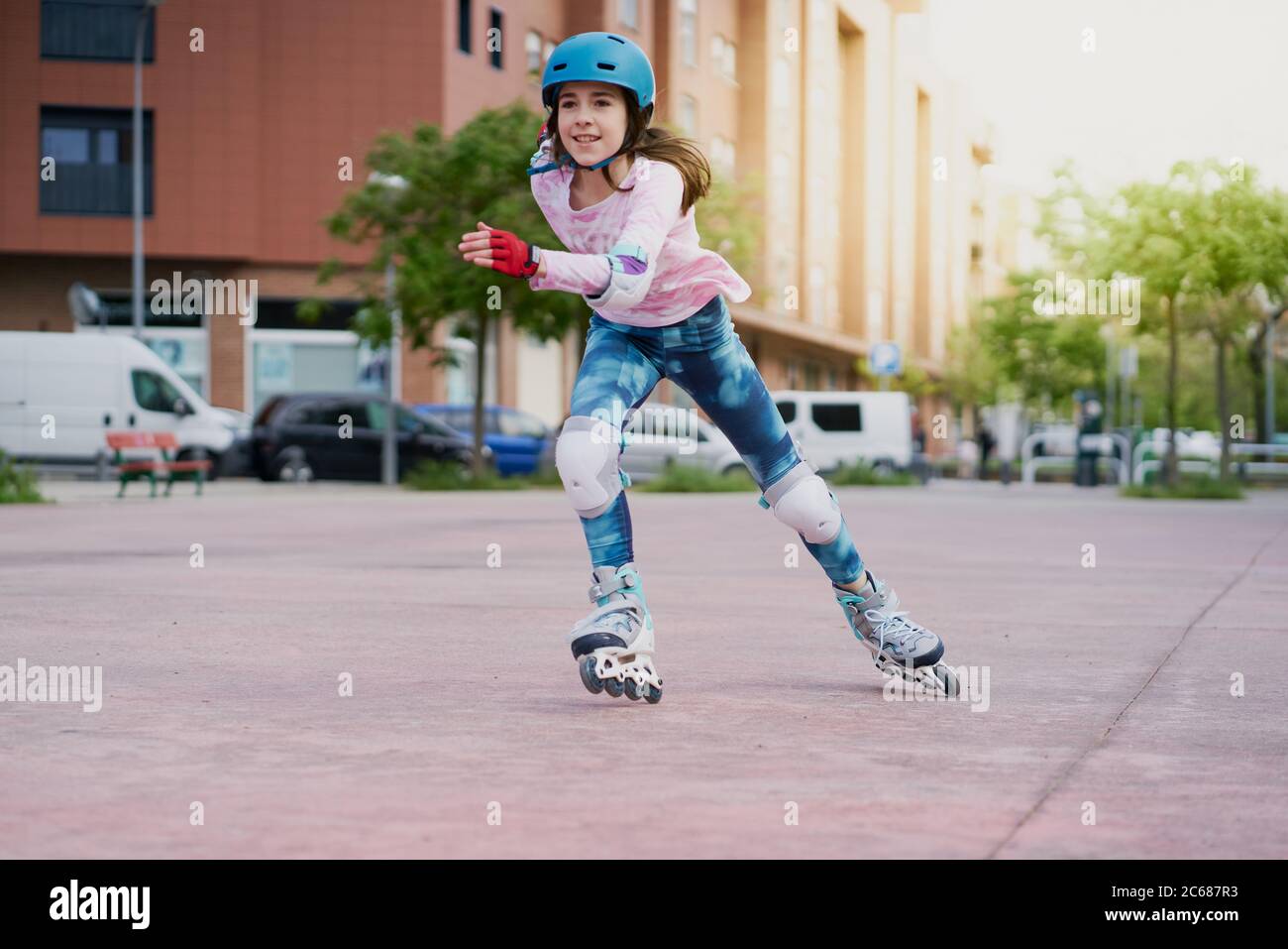 girl on the street skates with inline skates and helmet Stock Photo Alamy