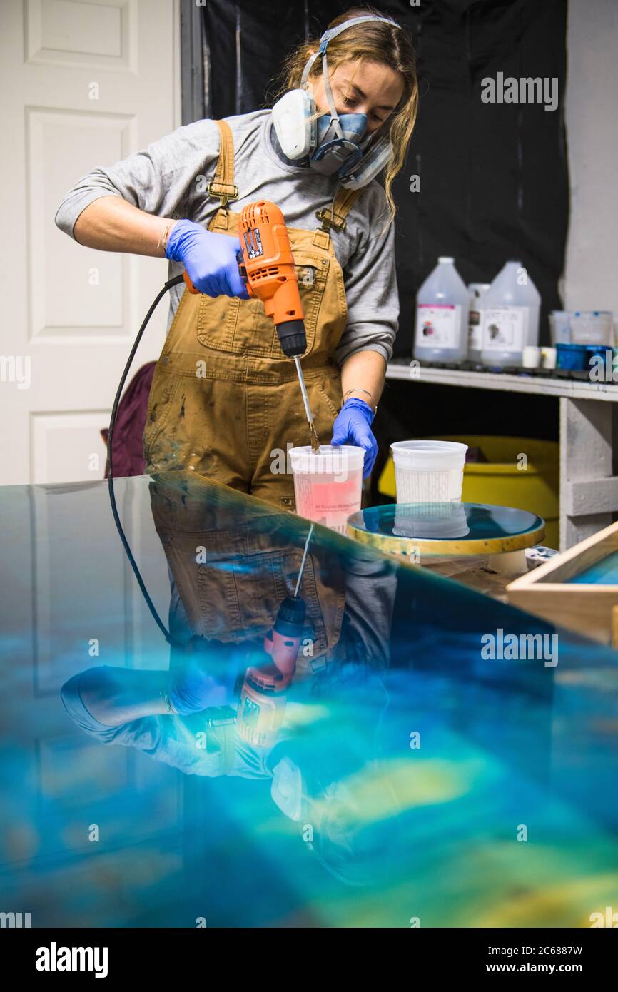 Female resin artist mixing with respirator mask Stock Photo Alamy