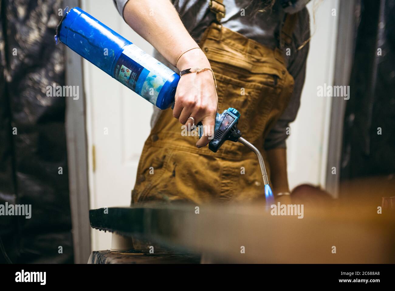 Female resin artist using blowtorch to finish artwork Stock Photo Alamy