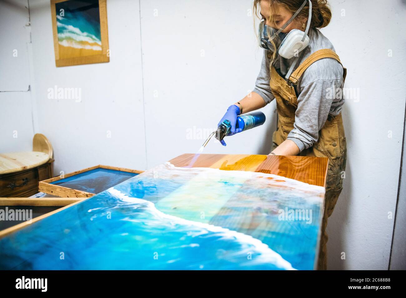 Female resin artist using blowtorch to perfect artwork Stock Photo Alamy