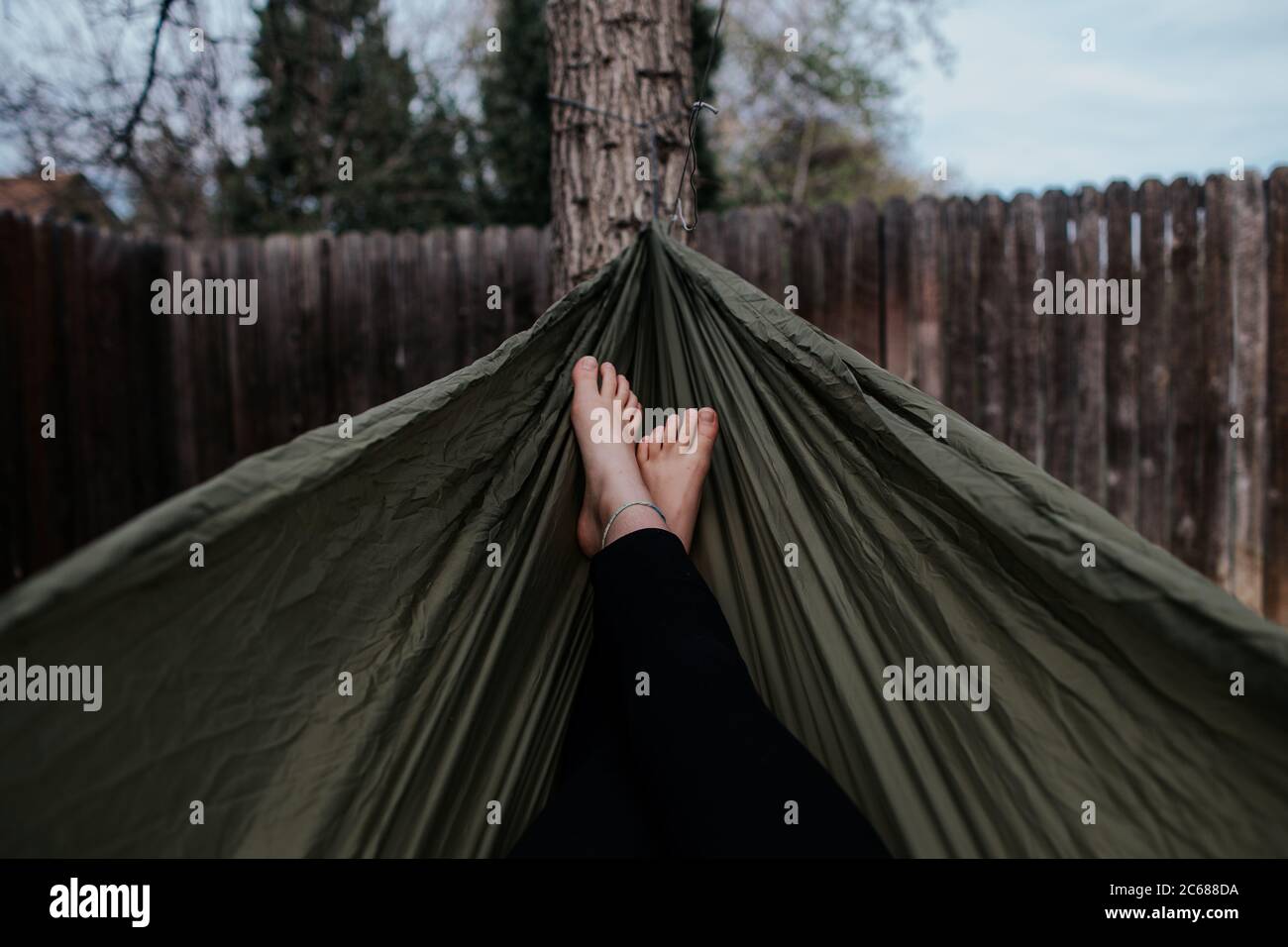 center shot of teen girl's feet in hammock Stock Photo